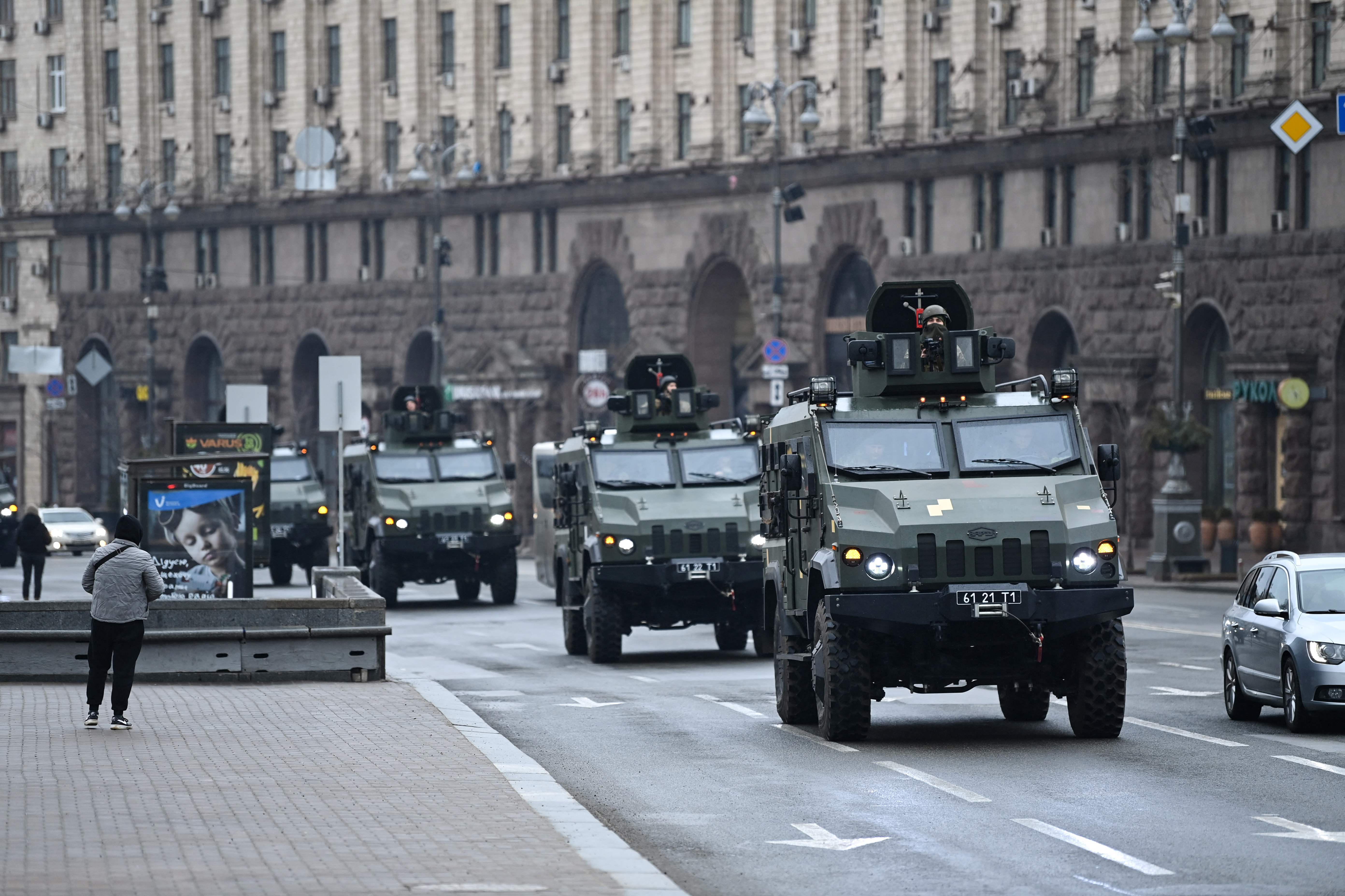 Ukrainian military vehicles move past Independence square in central Kyiv on 24 February 2022