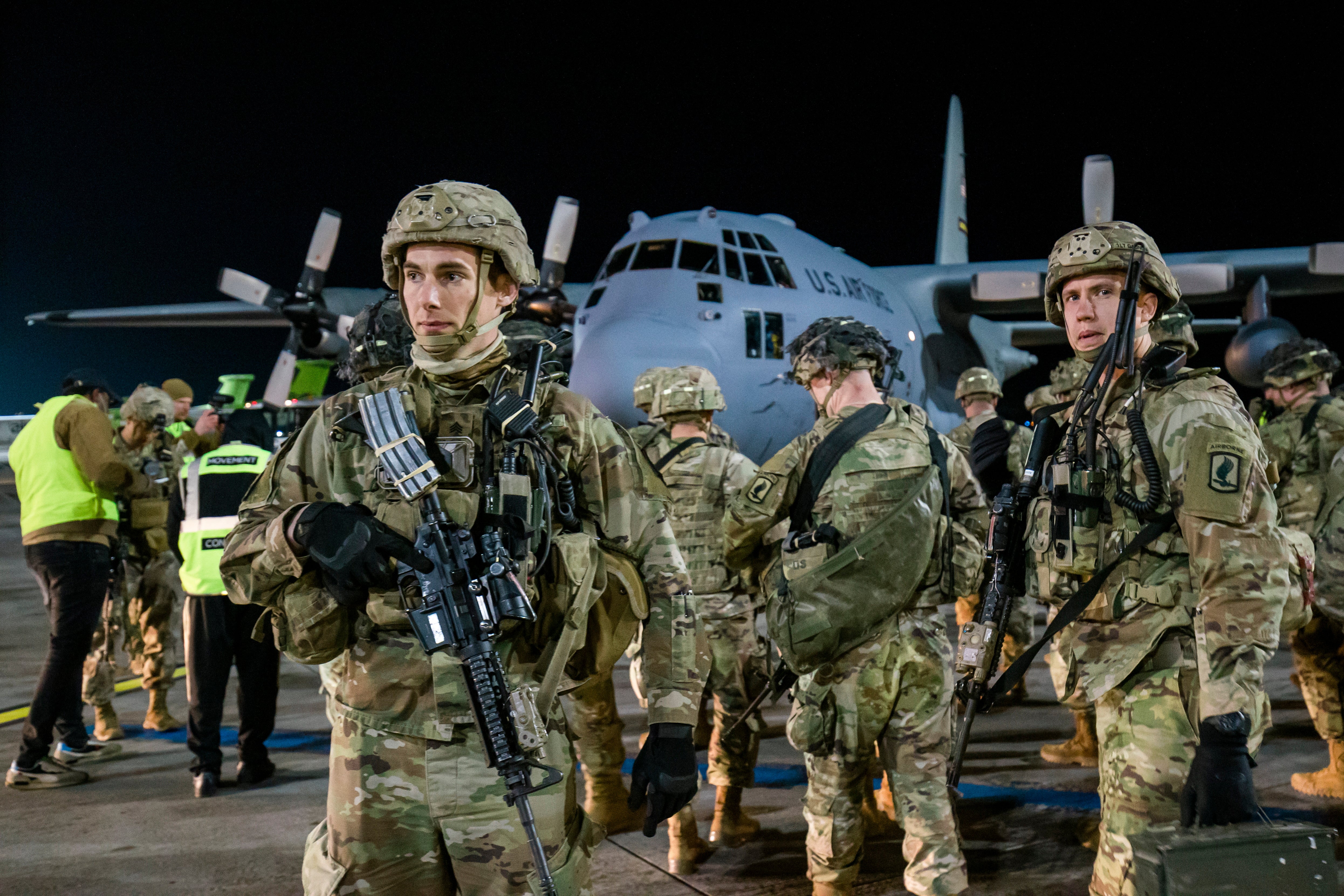 A handout photo made available by the Latvian Defence Ministry shows the first 40 soldiers of the 173rd U.S. Army Airborne Brigade after stepping off a military plane in Latvia, 24 February 2022