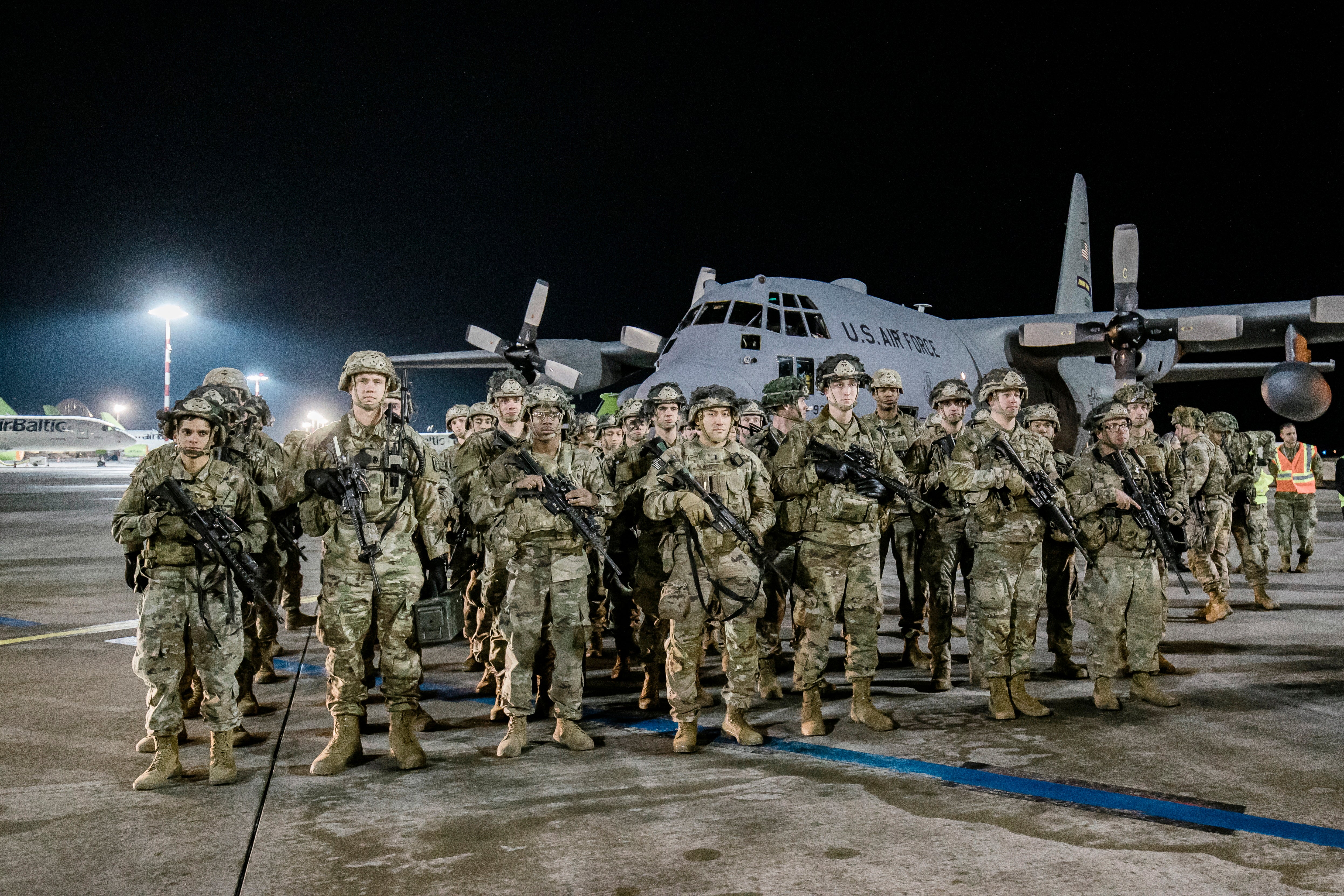 A handout photo made available by the Latvian Defence Ministry shows the first 40 soldiers of the 173rd U.S. Army Airborne Brigade after stepping off a military plane in Latvia, 24 February 2022