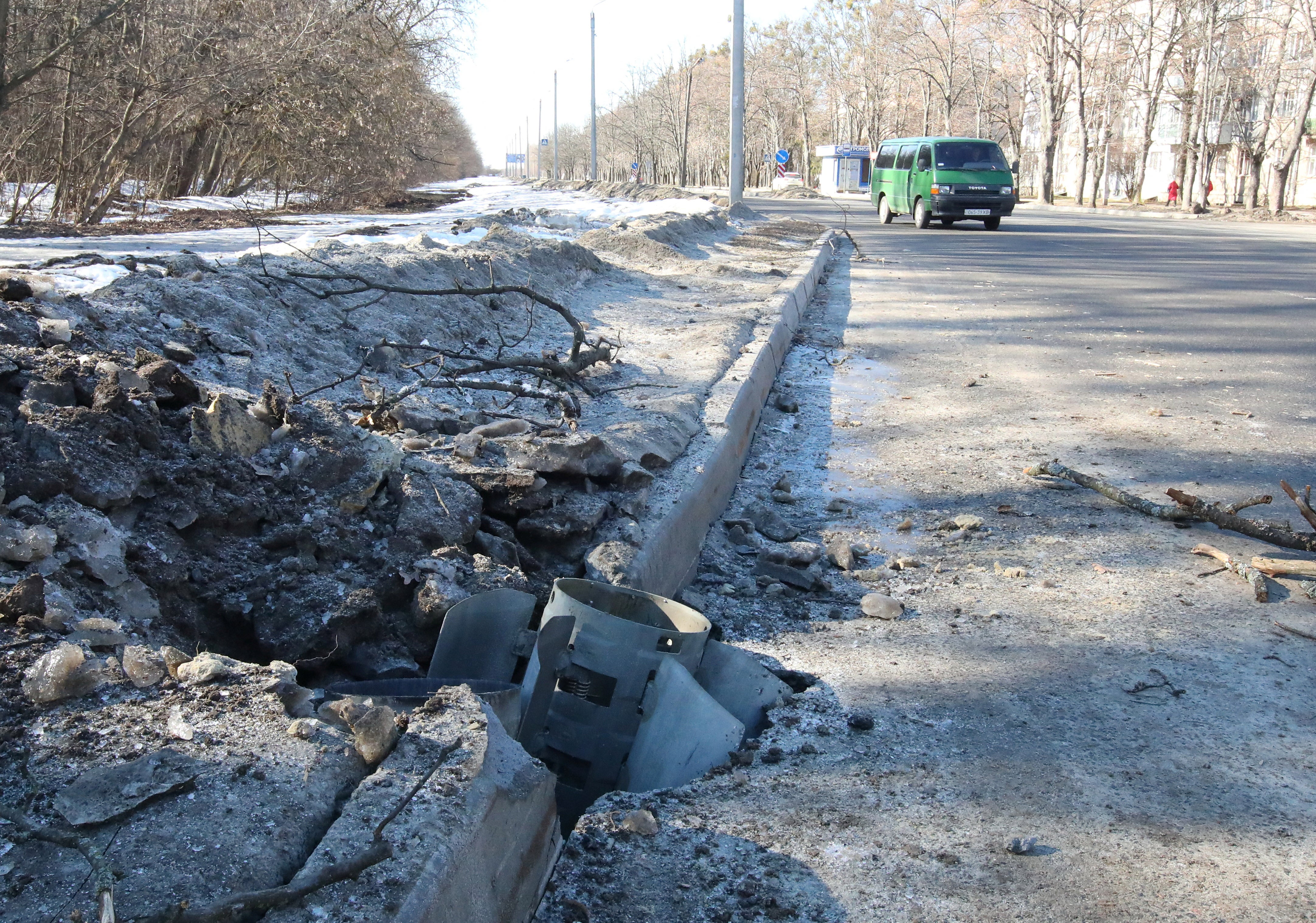 A rocket case lies buried into a road after recent shelling in Kharkiv, Ukraine 24 February 2022