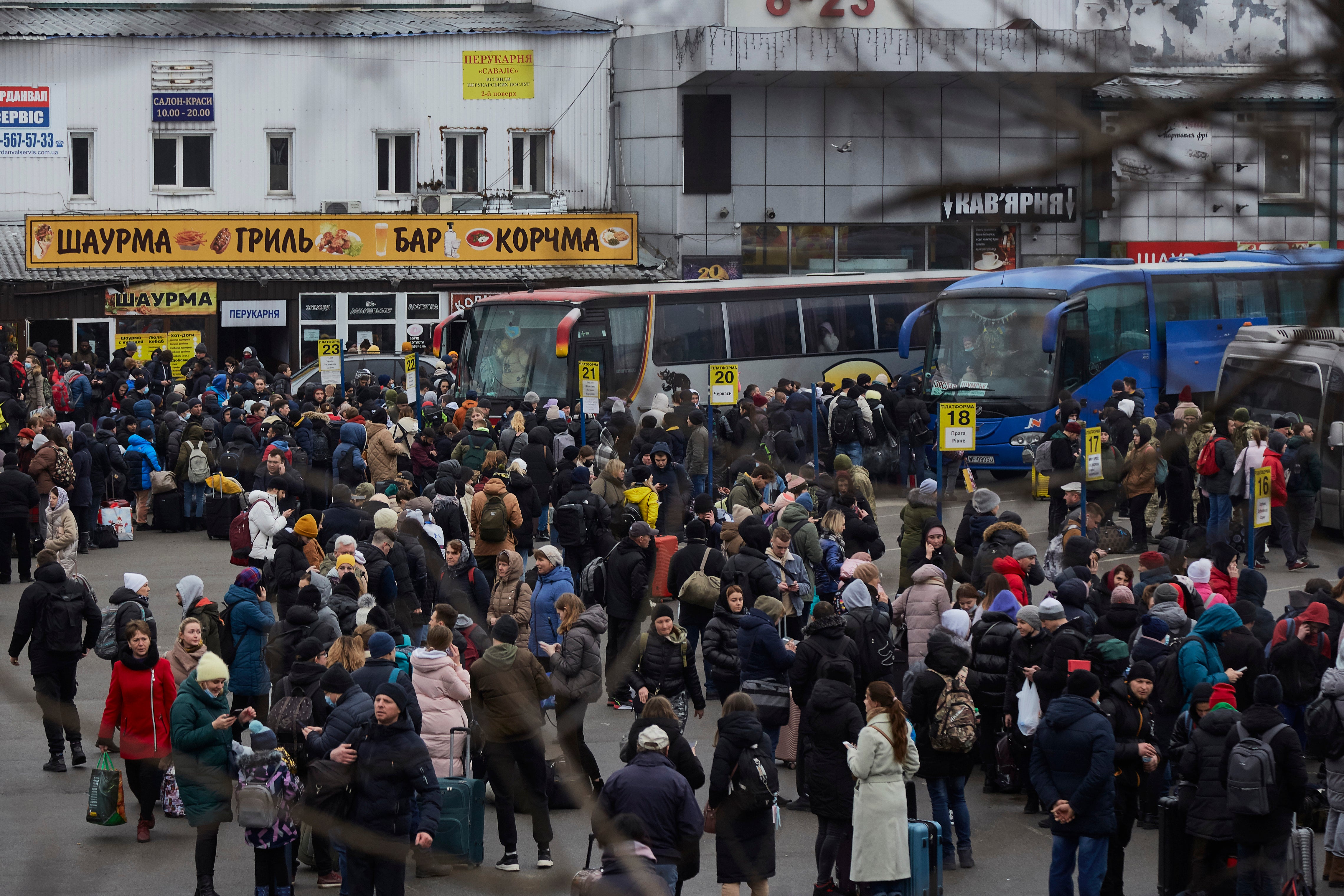 People wait for buses at a bus station as they attempt to evacuate the city on 24 February 2022 in Kyiv