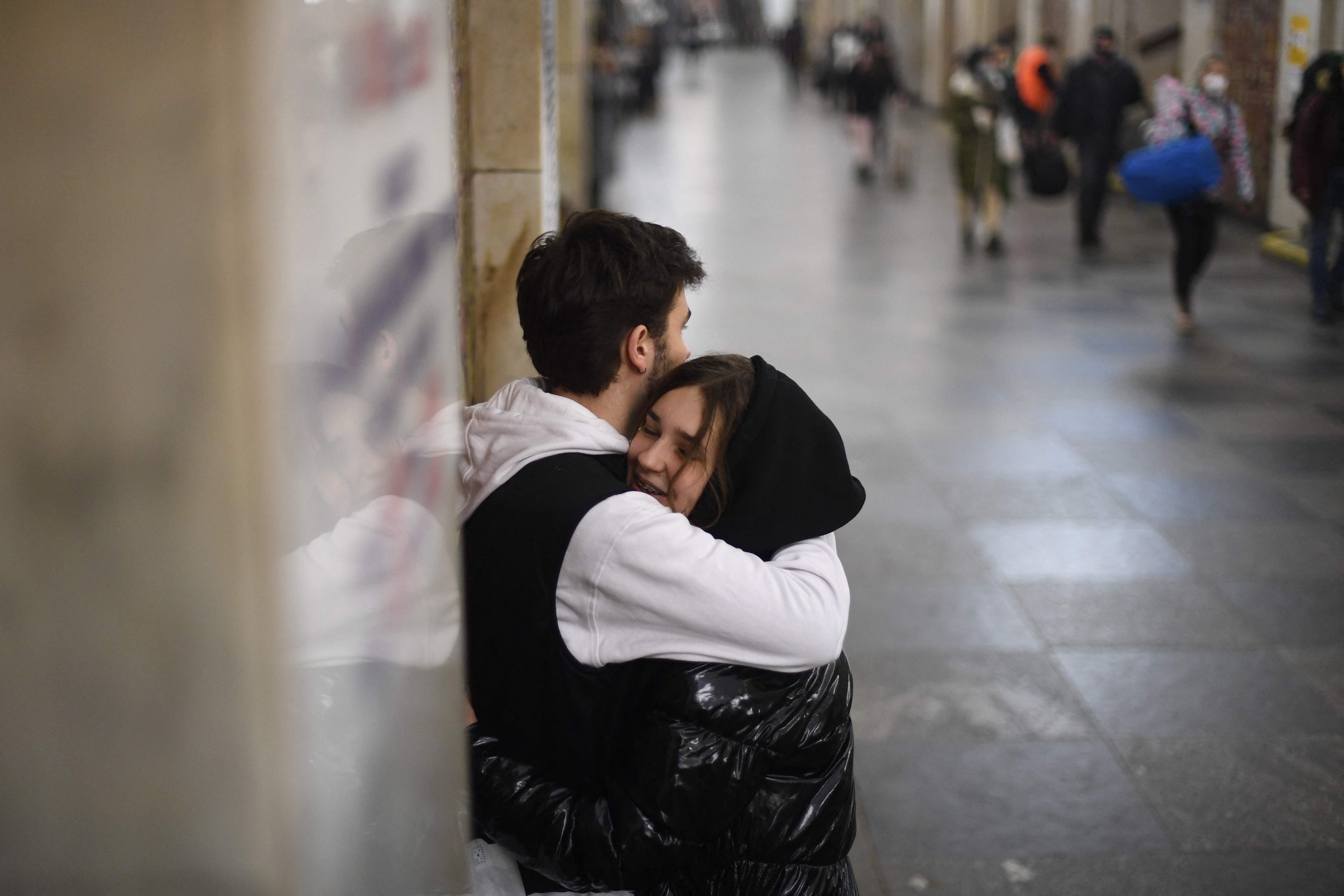 A couple hugs in Central Kiev as bombs rain down in the capital