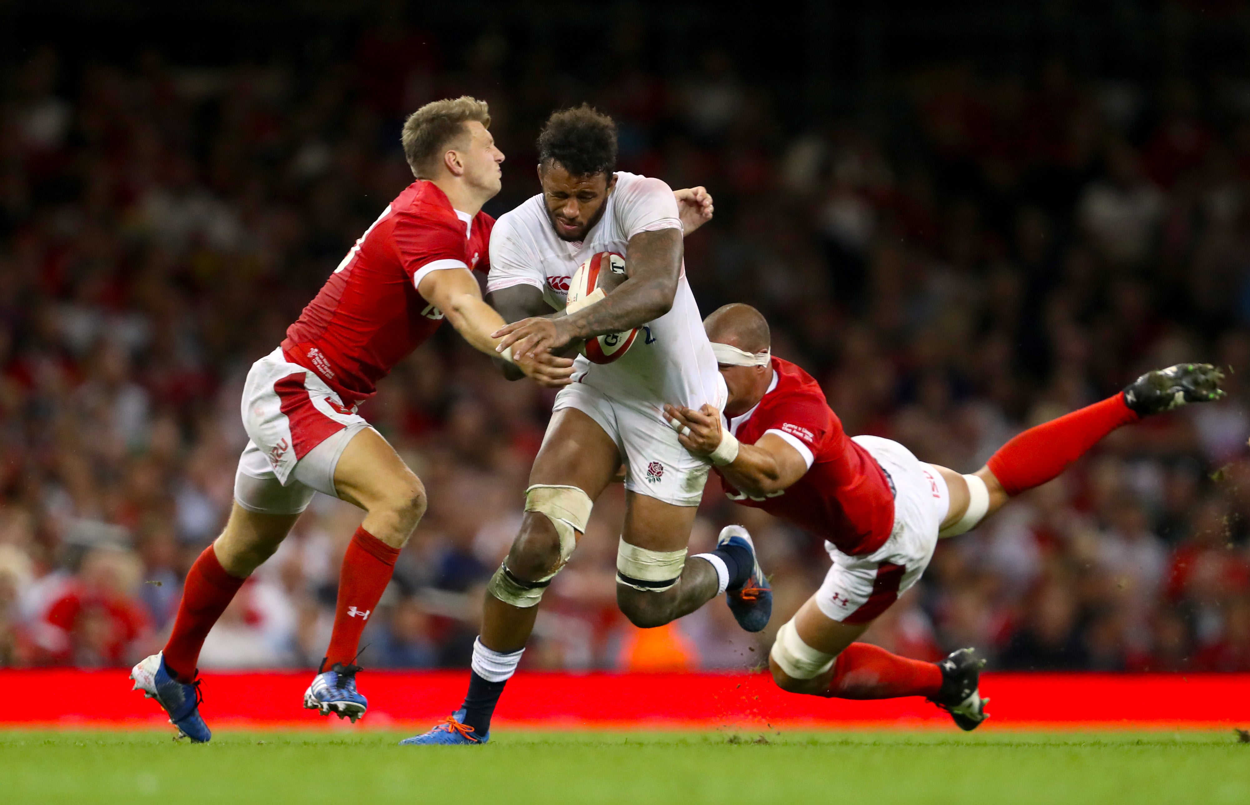 Dan Biggar (left) tackles Courtney Lawes during a Wales versus England game