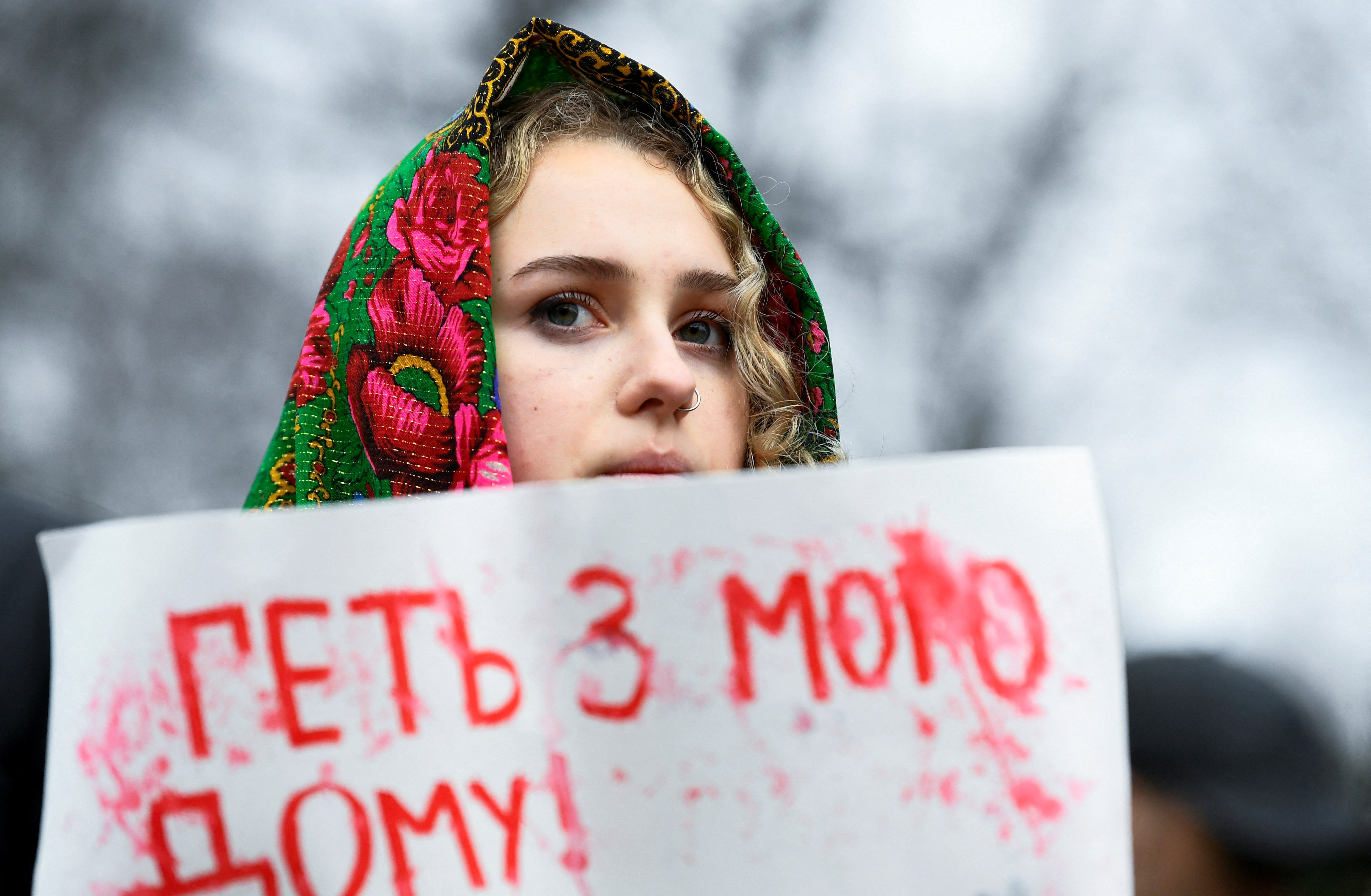 A demonstrator displays a placard during a protest against Russia's attack on Ukraine, outside the Dutch parliament in The Hague, Netherlands,