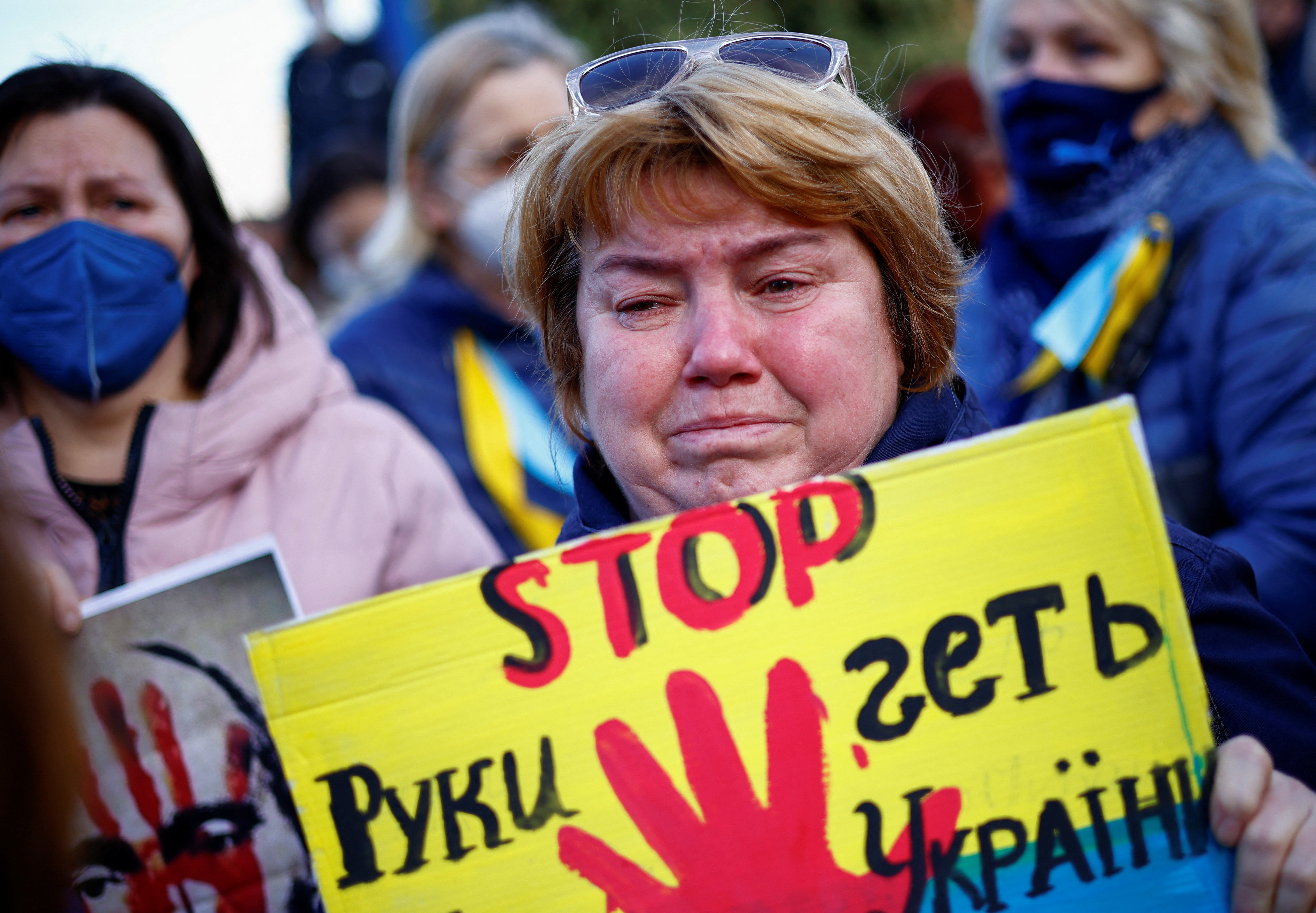 A demonstrator reacts during a protest outside the Russian Embassy, after Russian President Vladimir Putin launched a military operation in eastern Ukraine, in Rome, Italy