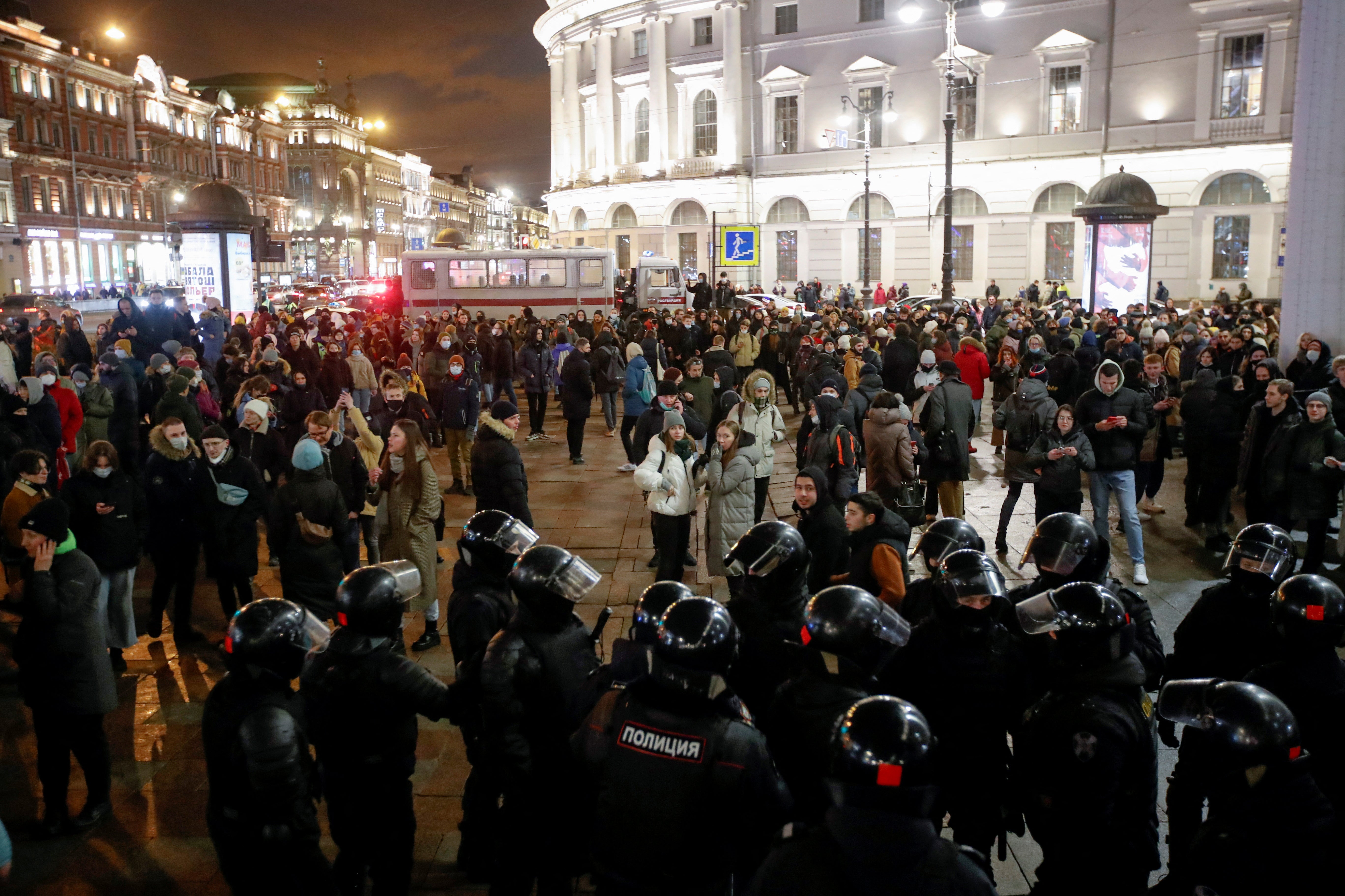 Officers gather near demonstrators during another anti-war protest in St Petersburg