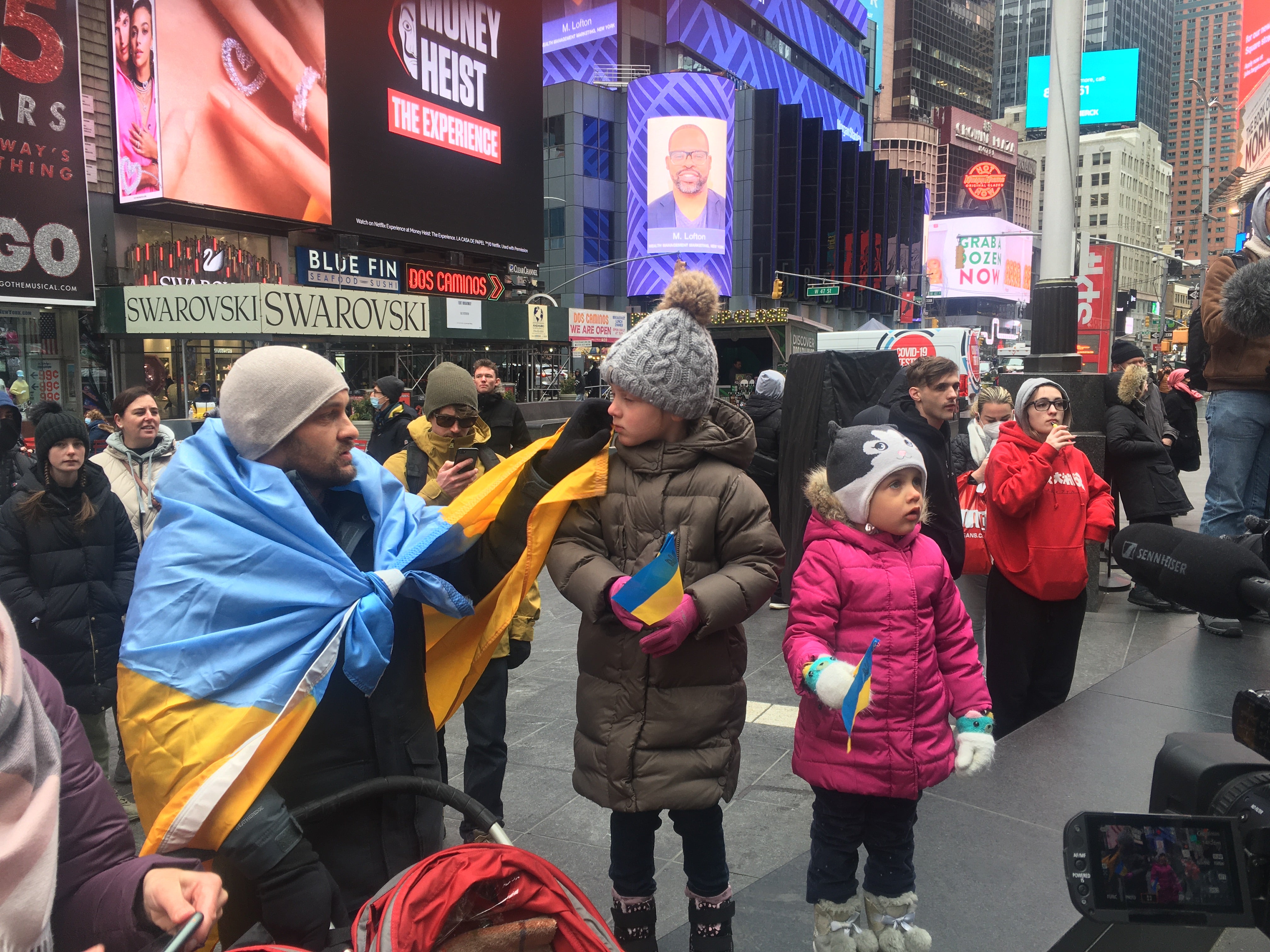 A Ukrainian family watches on as protesters chanted ‘Putin is a killer'