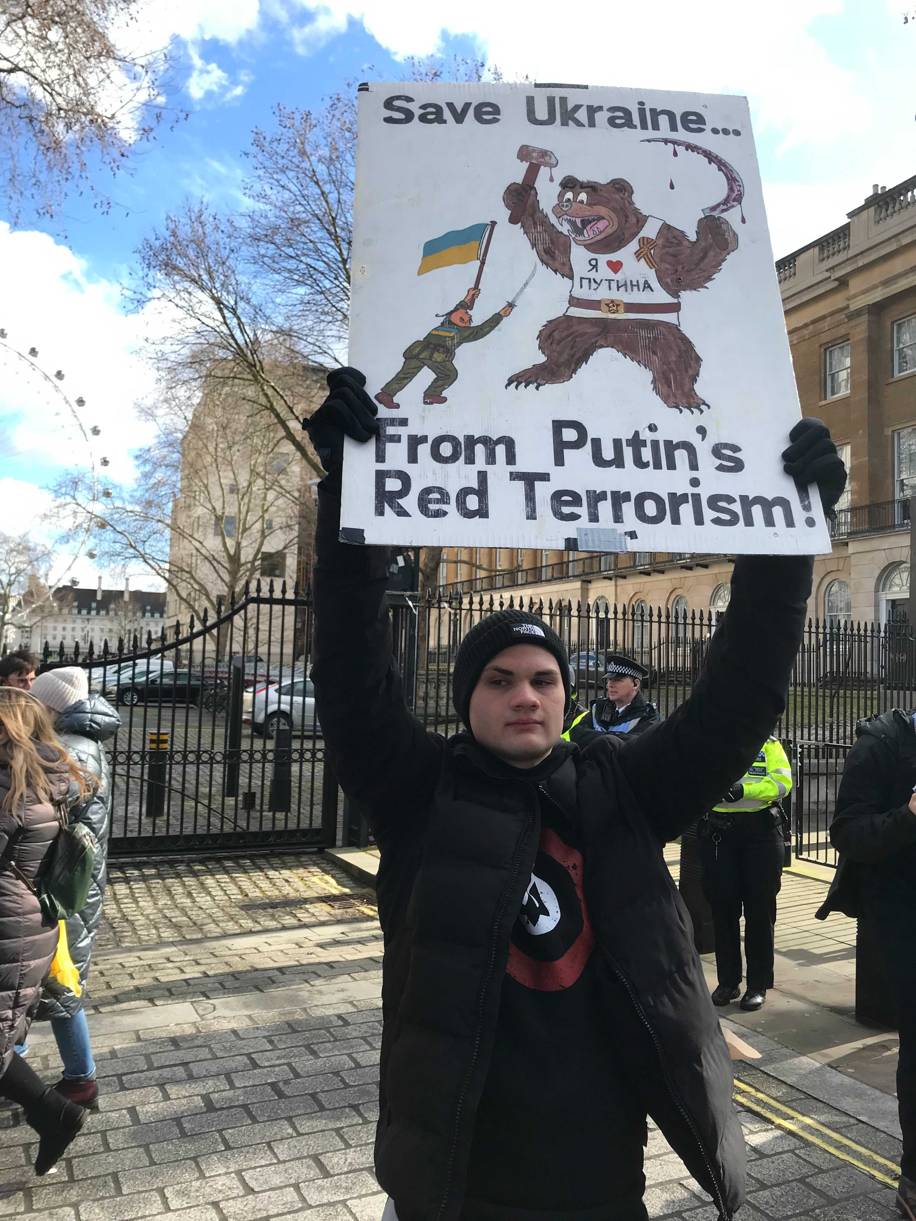 Vlad Chryskin, 16, holds up a placard at the protest