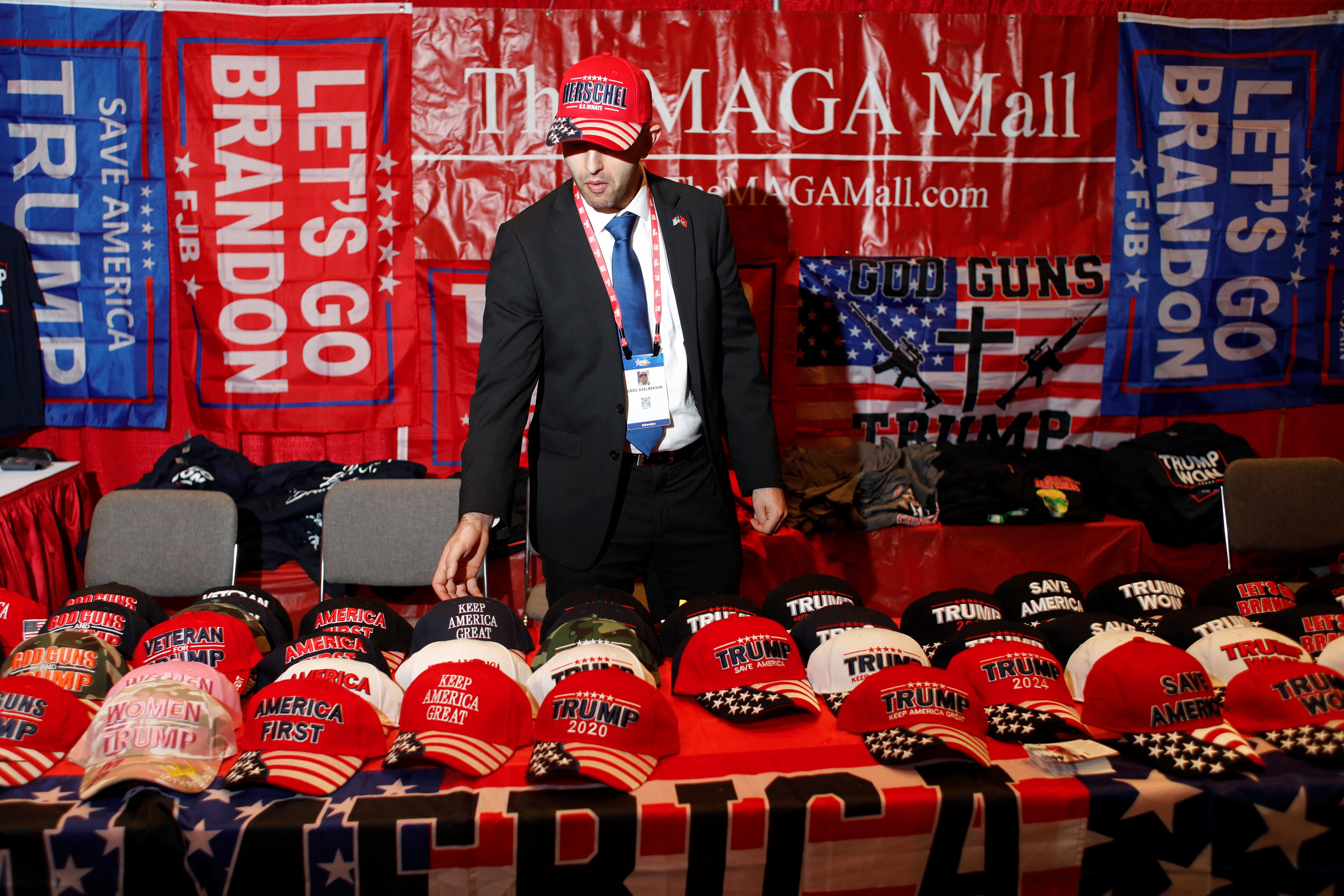 Greg Aselbekian, supporter of former President Trump, sells hats as he attends the Conservative Political Action Conference (CPAC) in Orlando, Florida, U.S. February 24, 2022. REUTERS/Octavio Jones