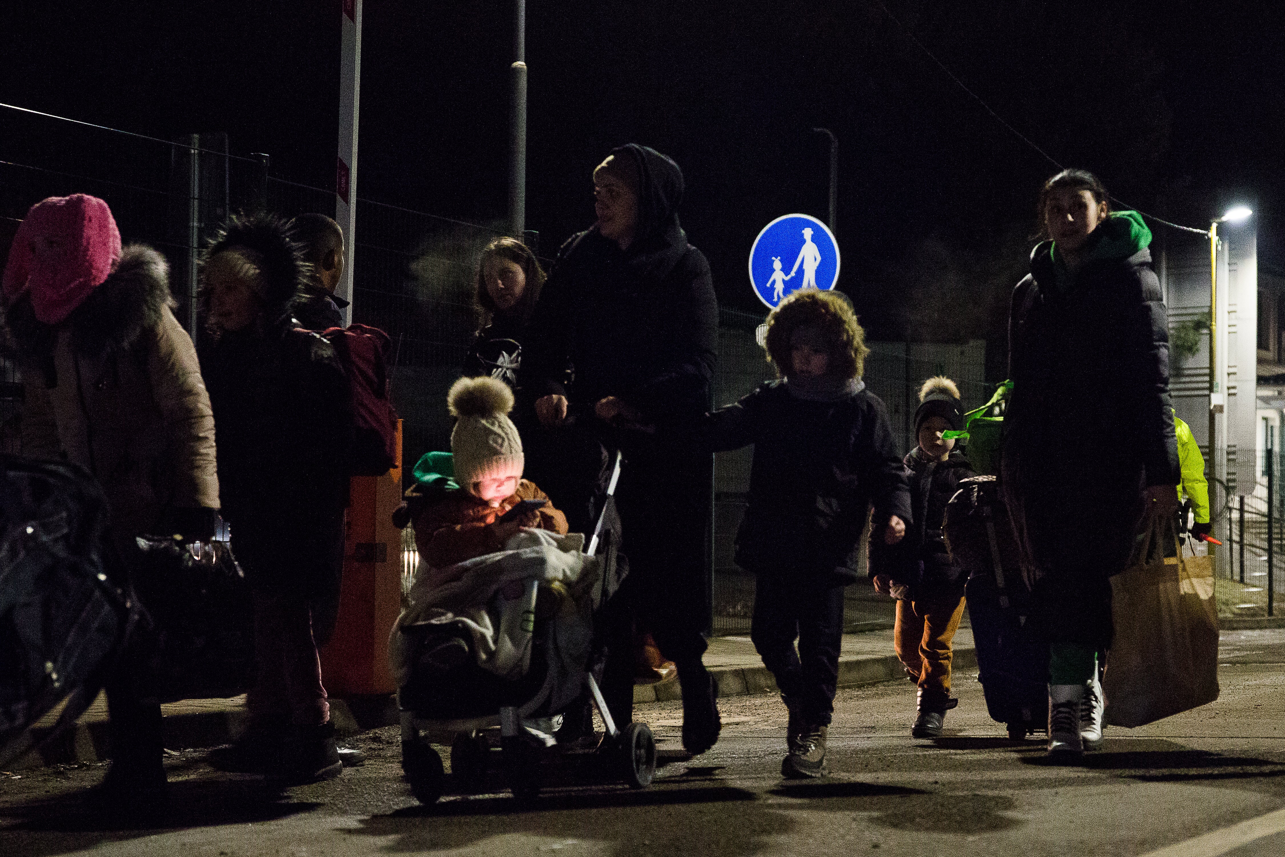 People walk on the street after crossing the Slovak-Ukrainian Internation crossing border on 24 February 2022