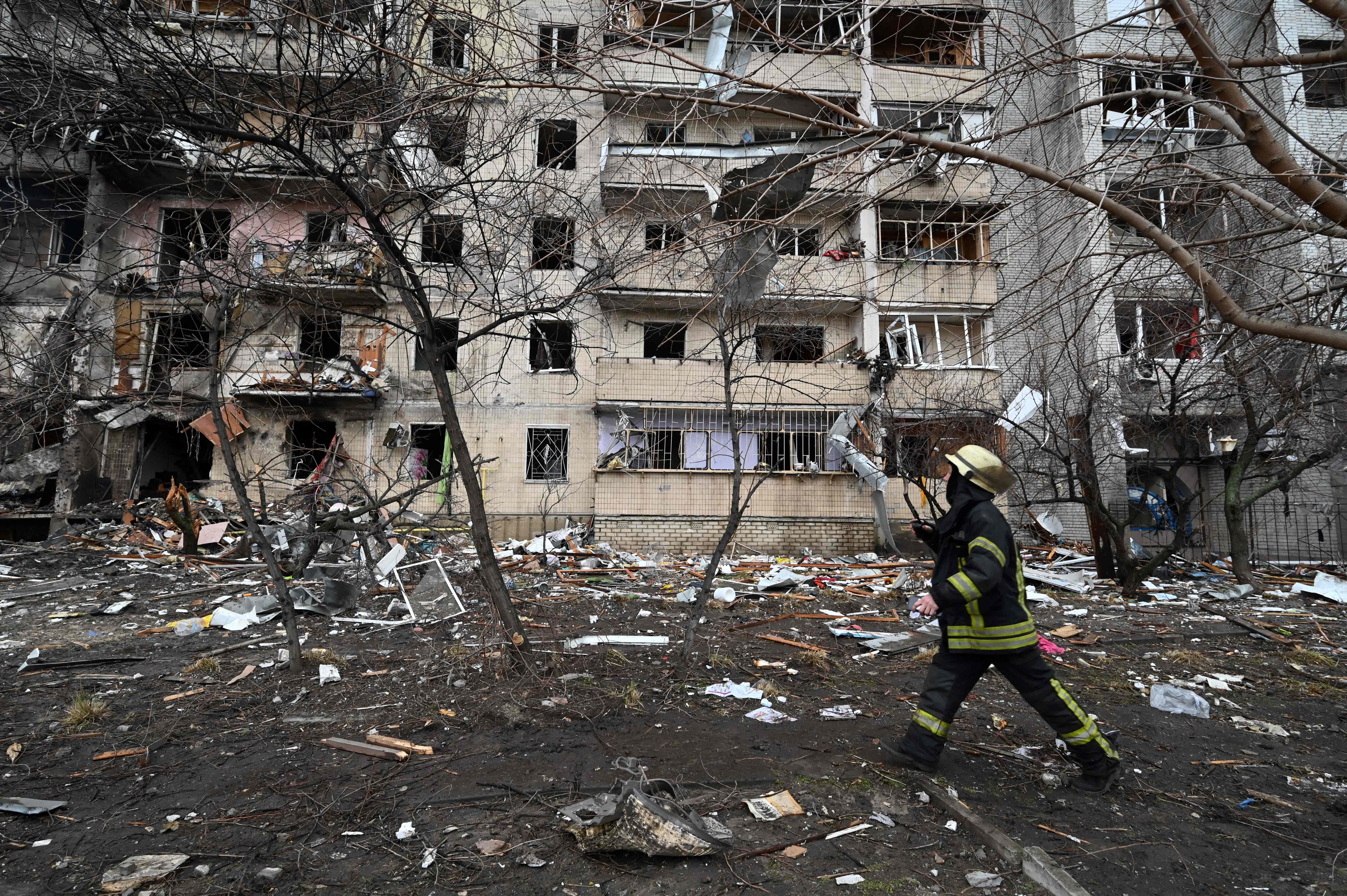 Firefighters work at a damaged residential building at Koshytsa Street, a suburb of the Ukrainian capital Kyiv