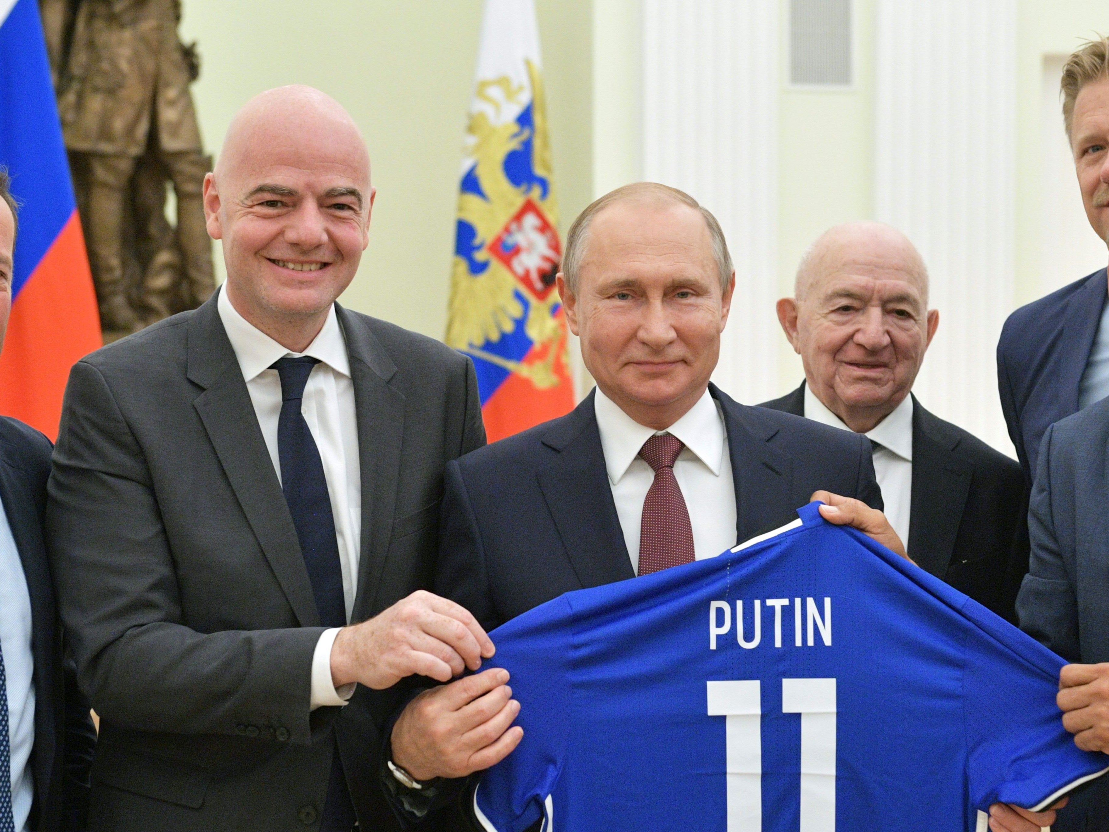 Fifa president Gianni Infantino presents Vladimir Putin with a shirt at the Kremlin during the 2018 World Cup finals. Football has become increasingly intertwined with business interests from Russia