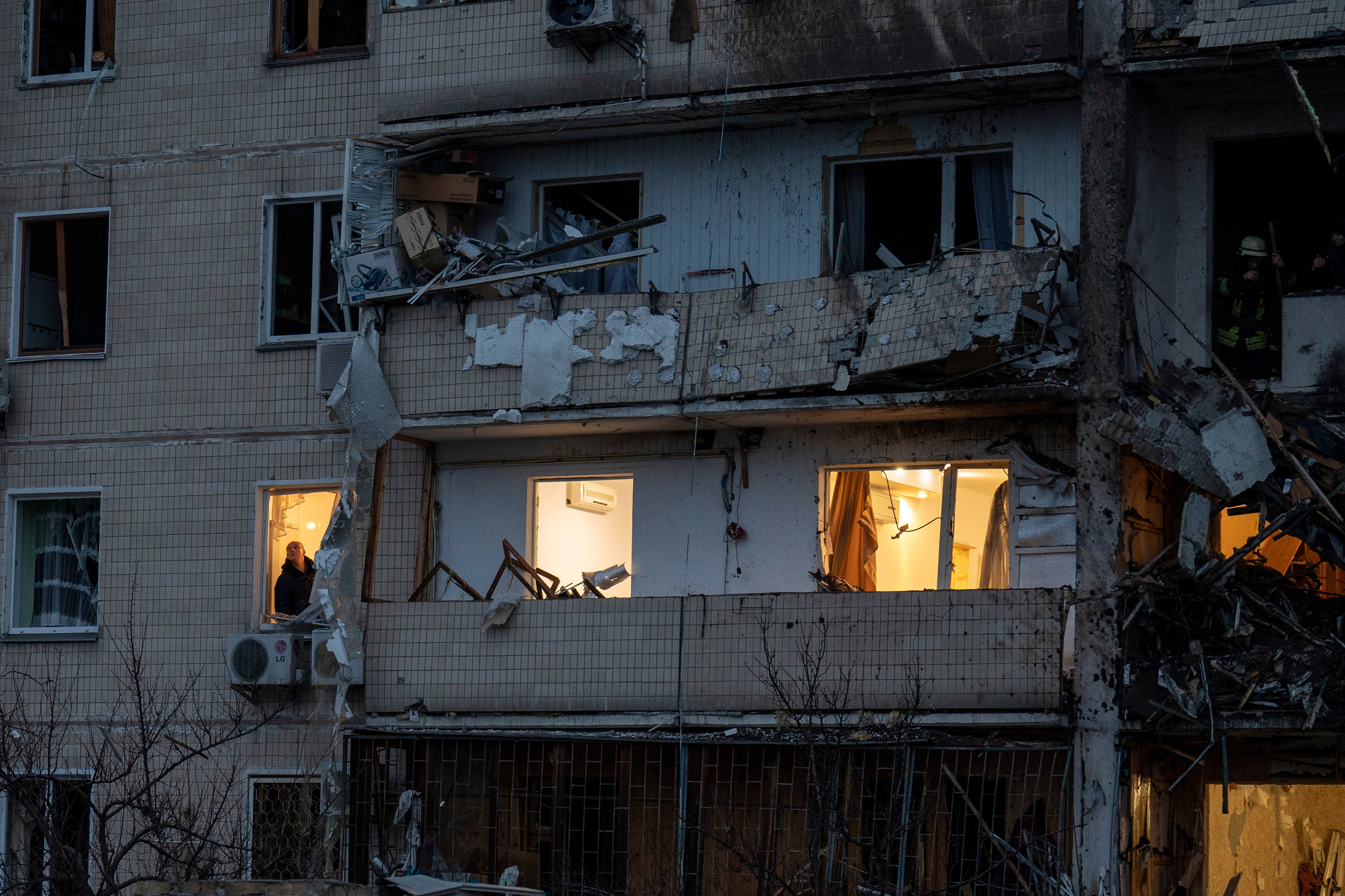 A man inspects the damage following a rocket attack in Kyiv (Emilio Morenatti/AP)