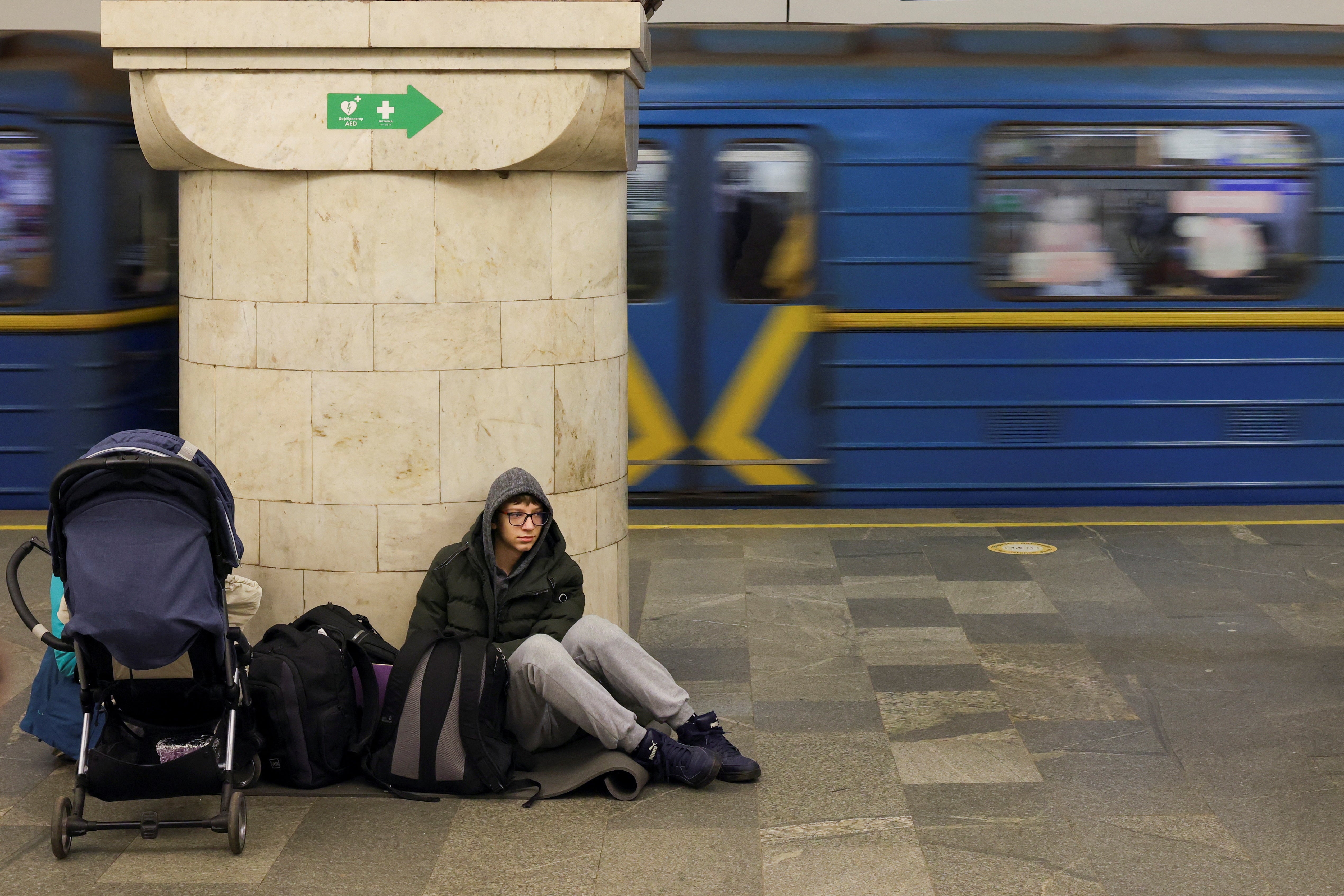 A boy takes shelter at a metro station in Kyiv