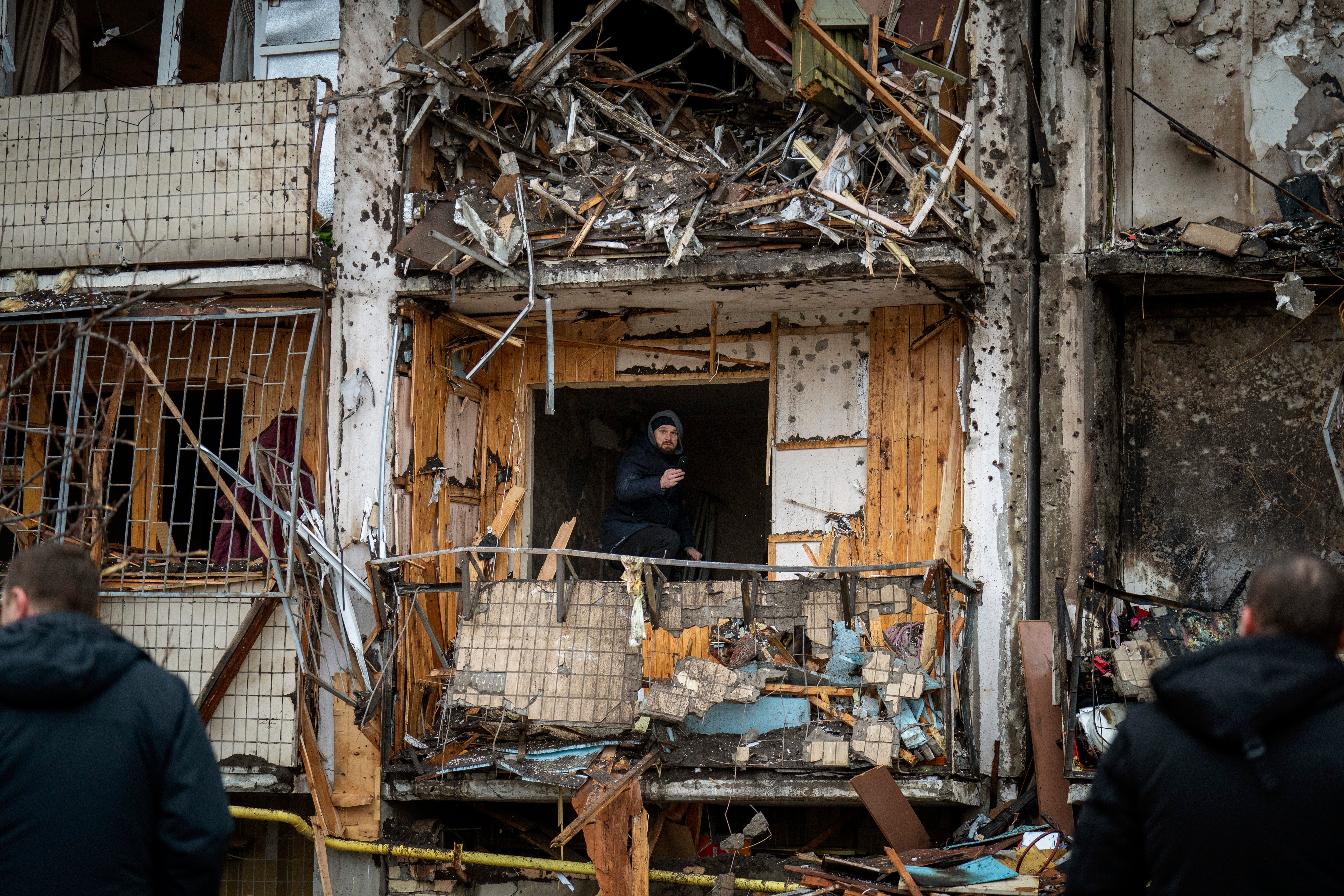 A man inspects the damage at a building following a rocket attack on the city of Kyiv