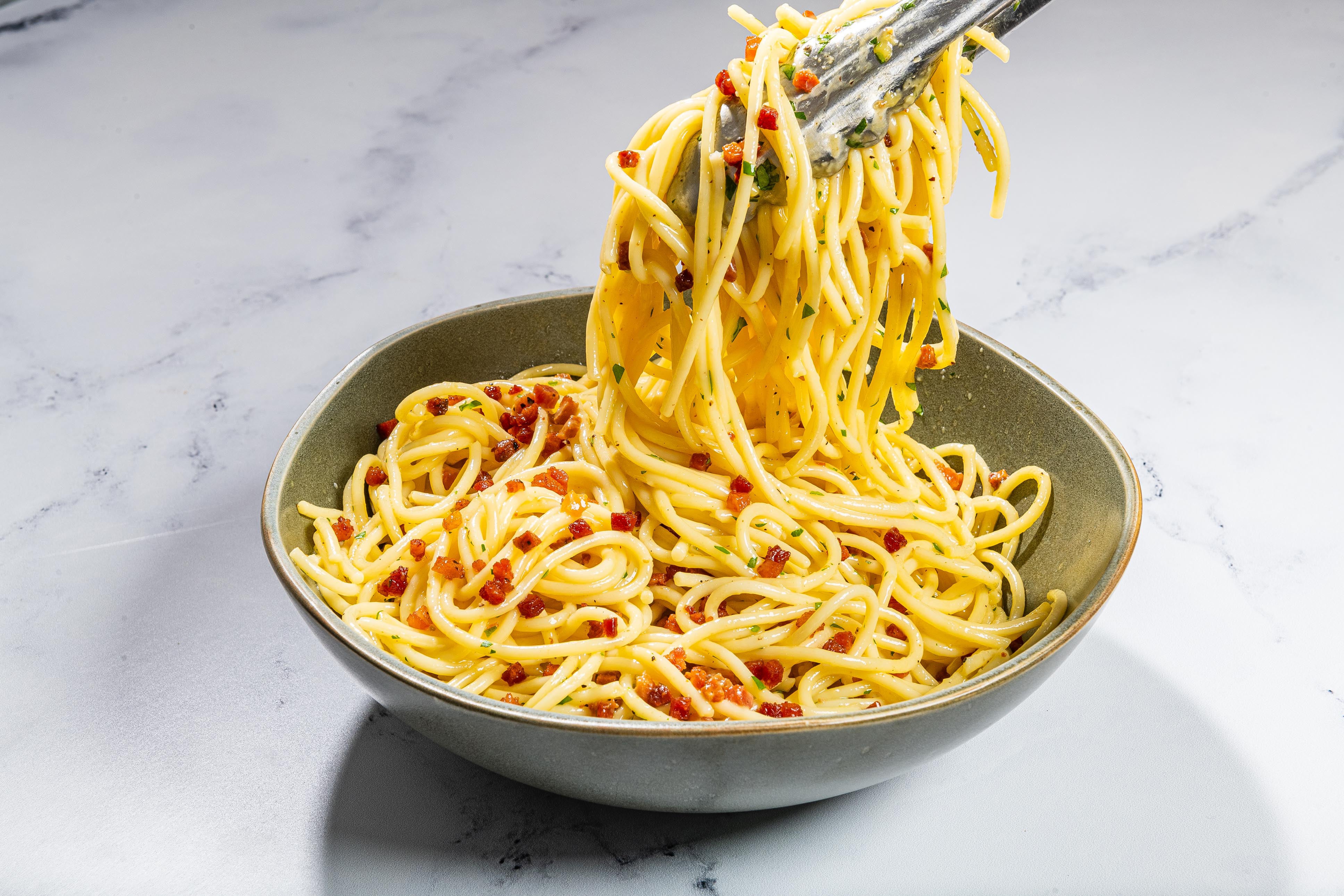 Toss together the carbonara in the serving bowl and dish out right away.