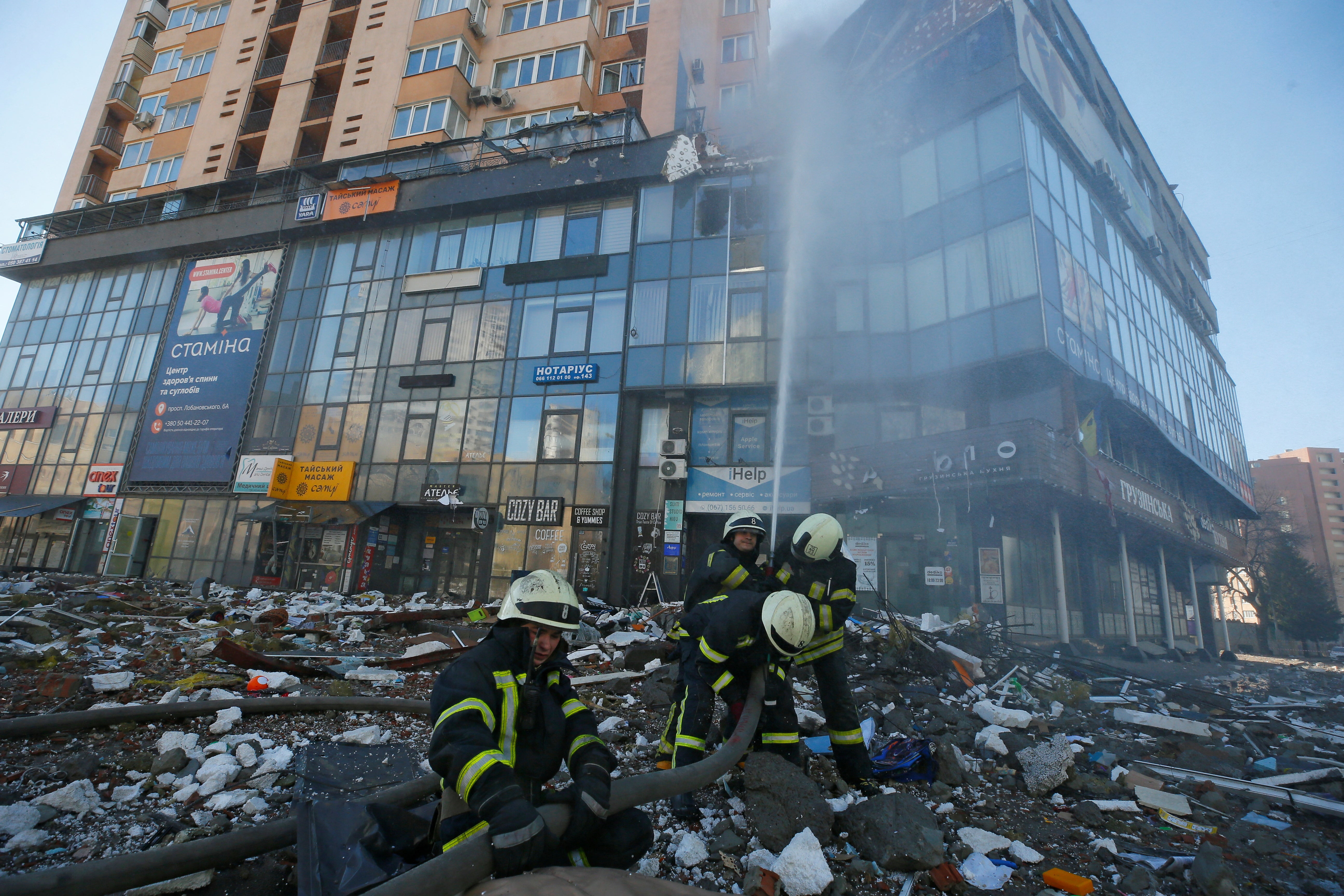 Firefighters at an apartment building damaged by recent shelling in Kyiv