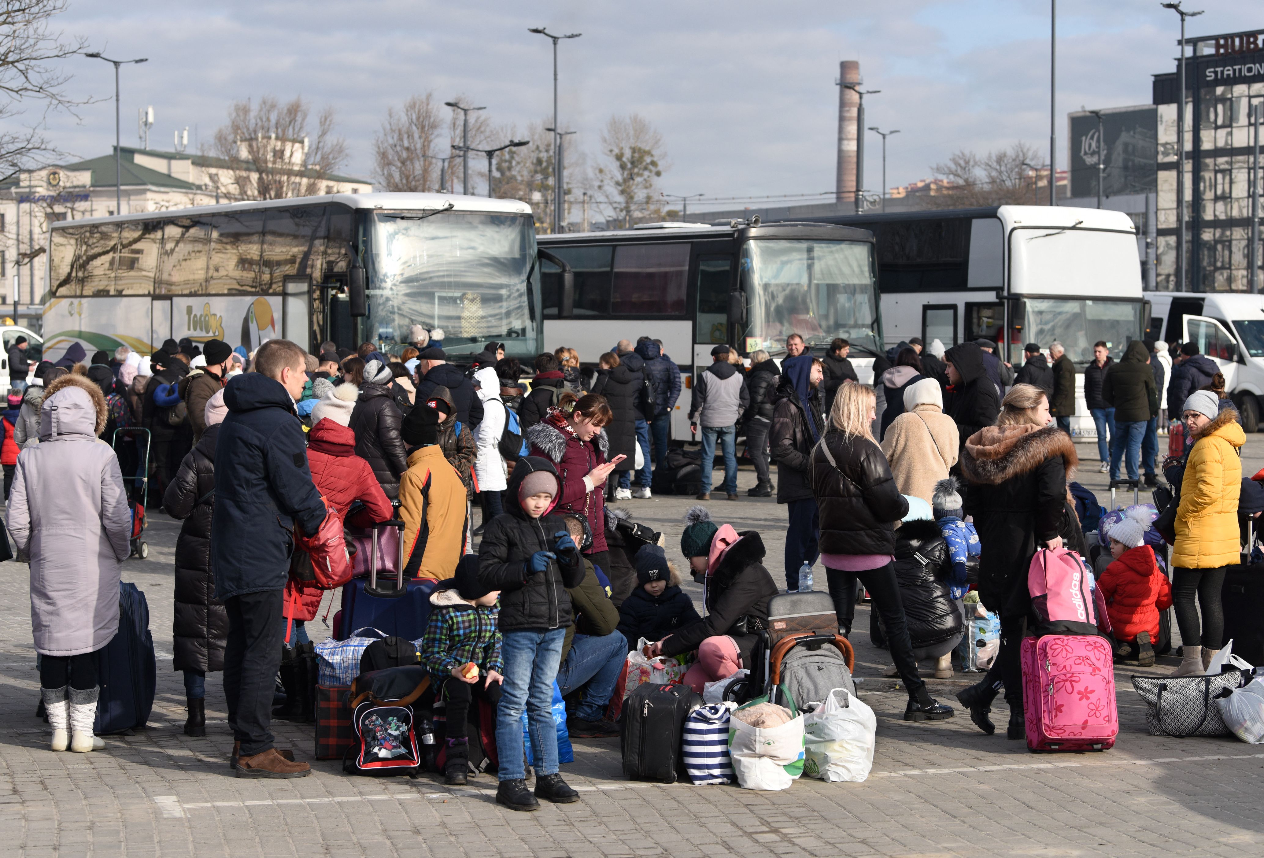 People wait for a bus to Poland at a bus station Lviv on Saturday