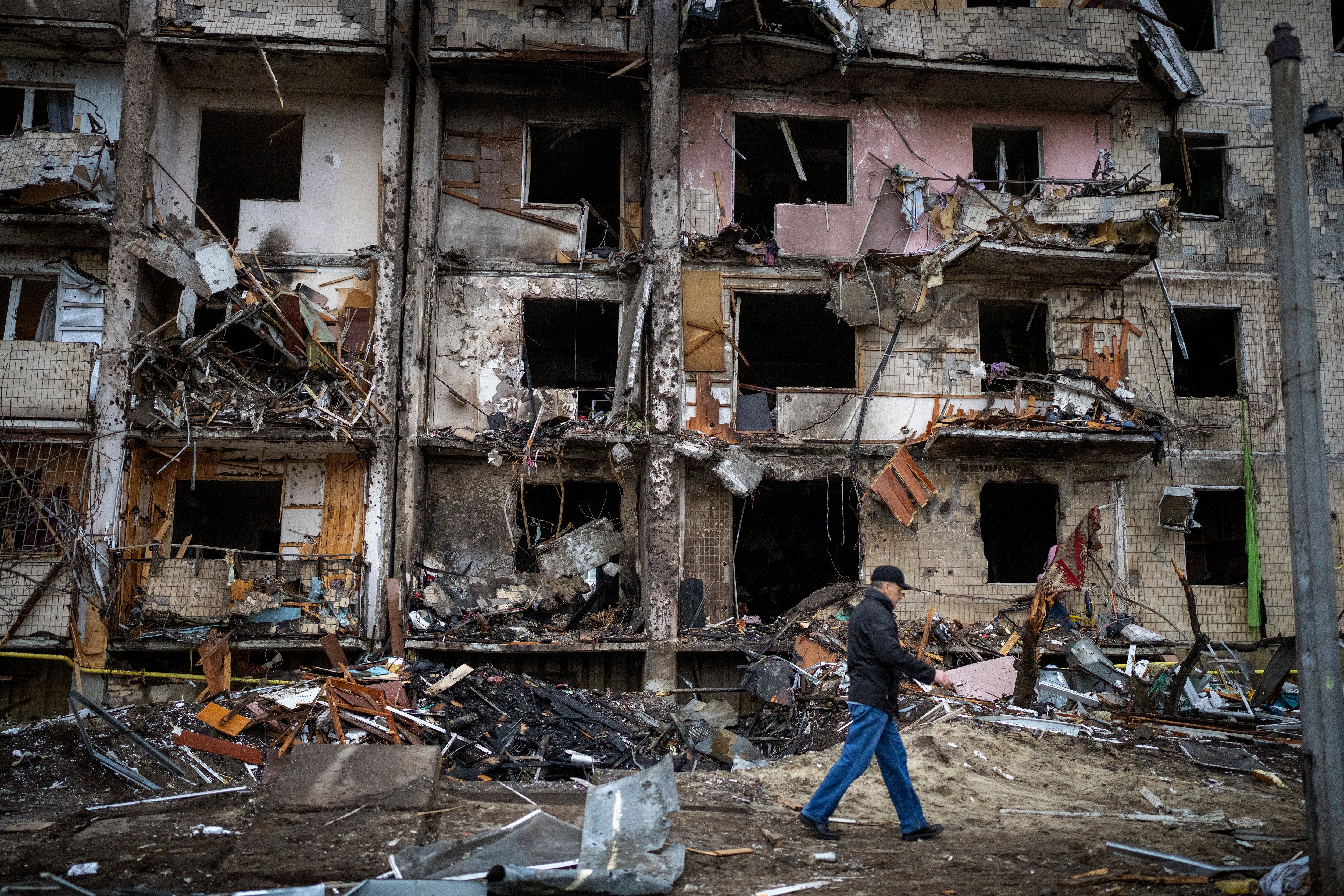 A man walks past a building damaged following a rocket attack, in Kyiv, Ukraine