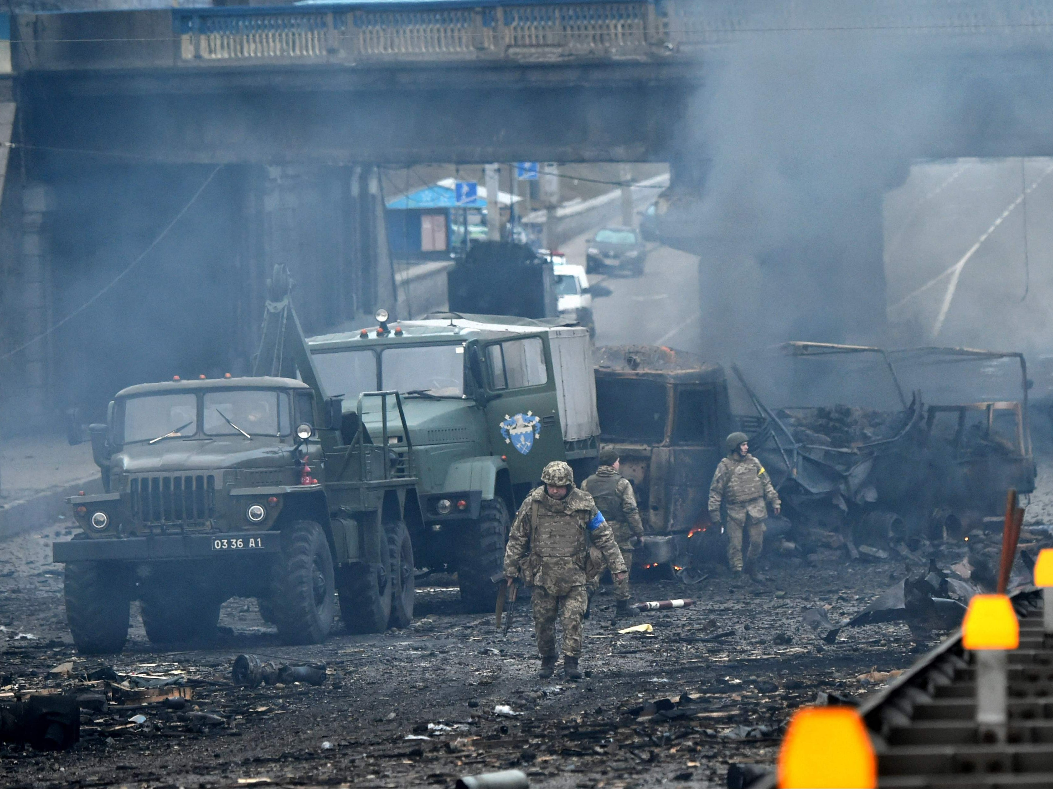 Ukrainian service members are seen at the site of a fighting with Russian raiding group in the Ukrainian capital of Kyiv