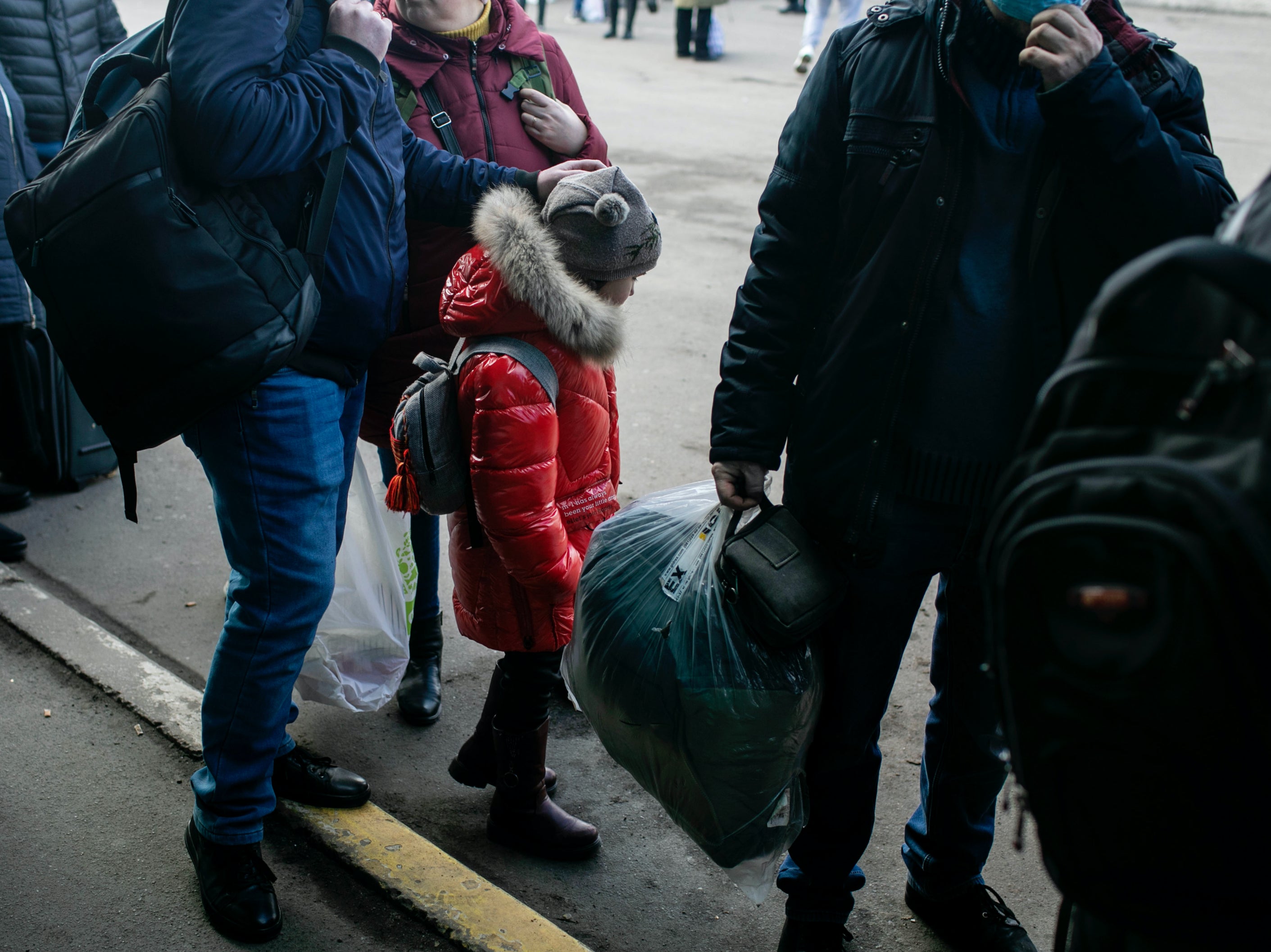 People waiting for a bus to take them out of Kyiv, Ukraine