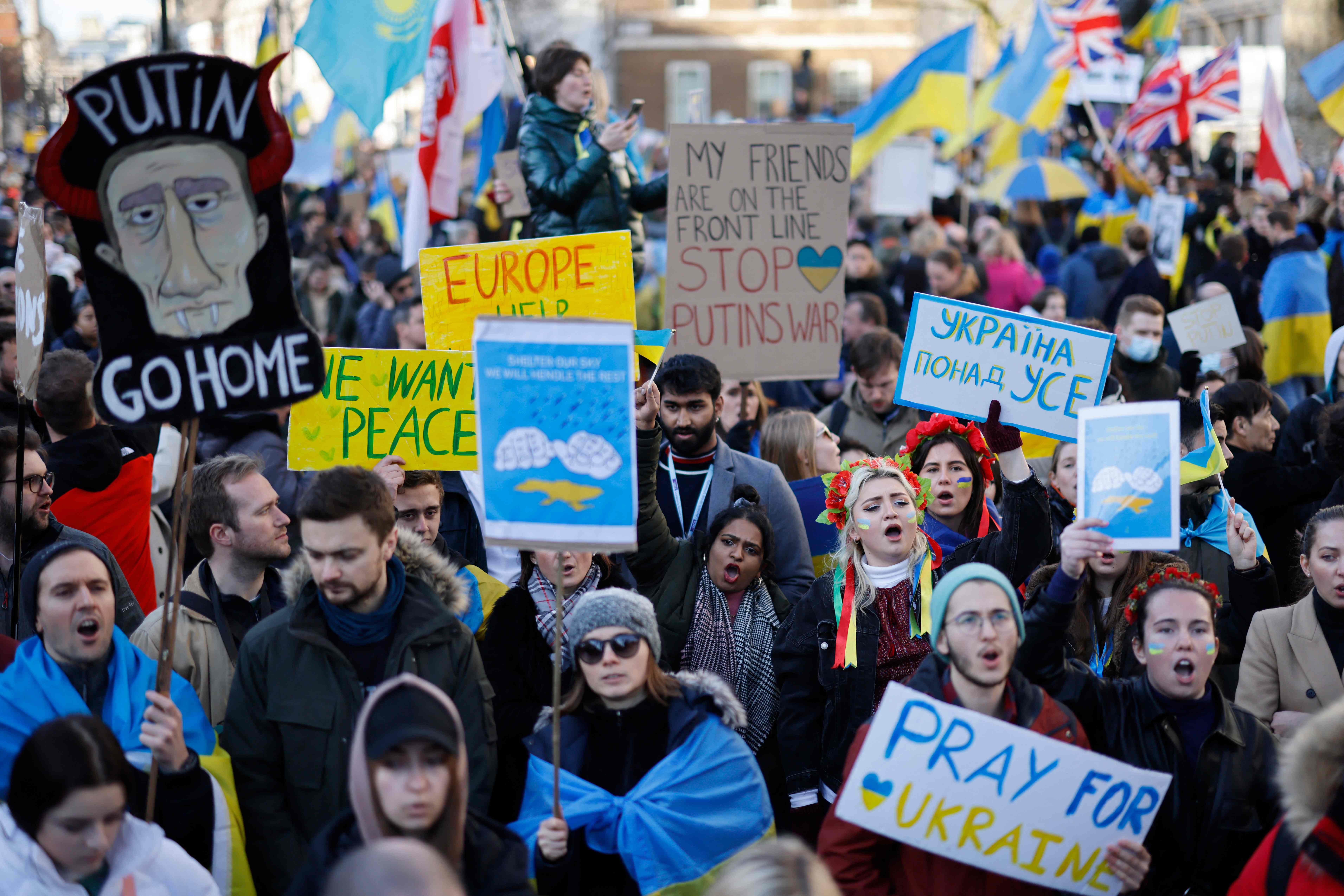 Demonstrators hold placards at the rally in central London