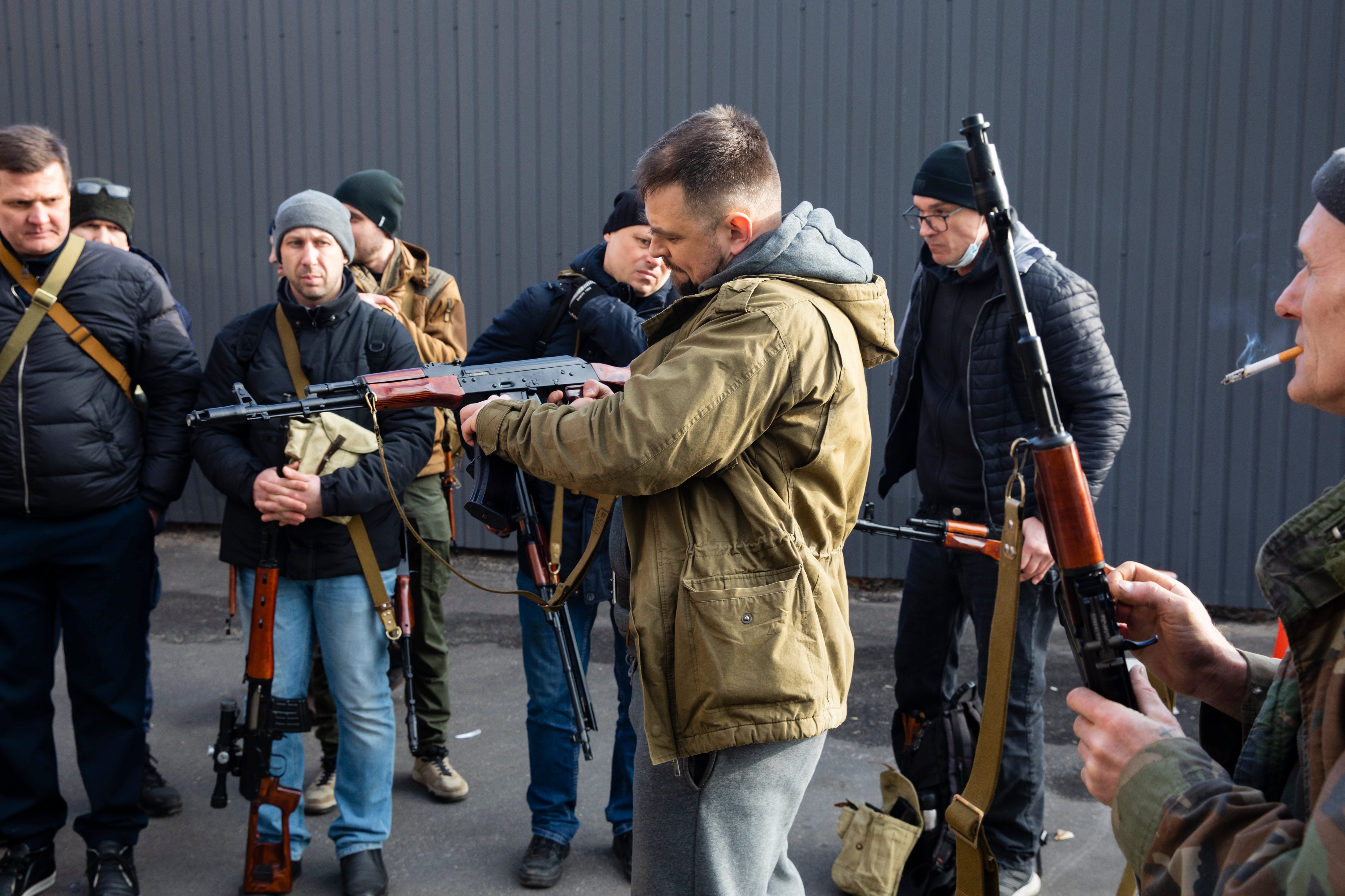 Civilian Members of a territorial defence unit fit their weapons to repel the Russian attacking forces in Kyiv, Ukraine, Saturday, Feb. 26, 2022.