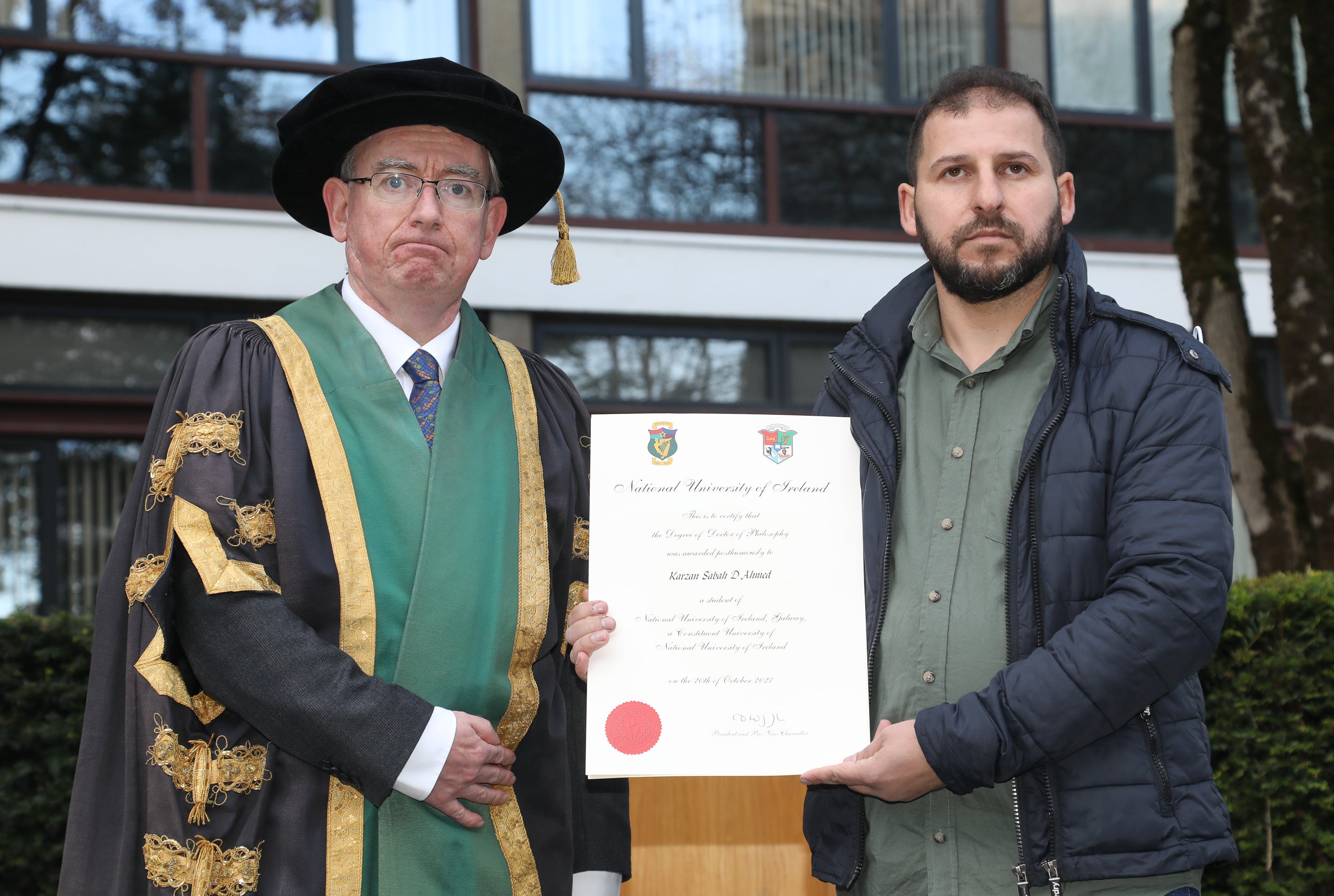 NUI Galway president Ciaran O Hogartaigh presenting the Karzan Sabah D Ahmed parchment to Ahmed Mahmud (NUI Galway/PA)