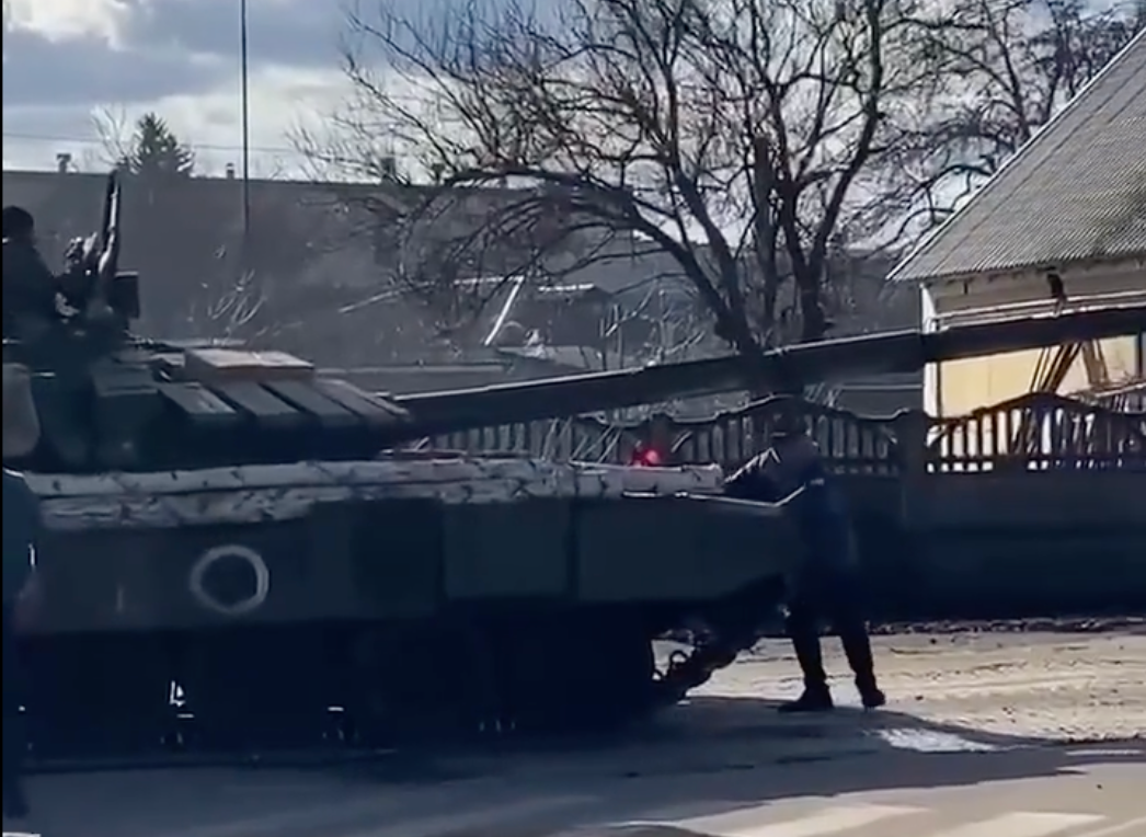 The man stood in front of a Russian tank