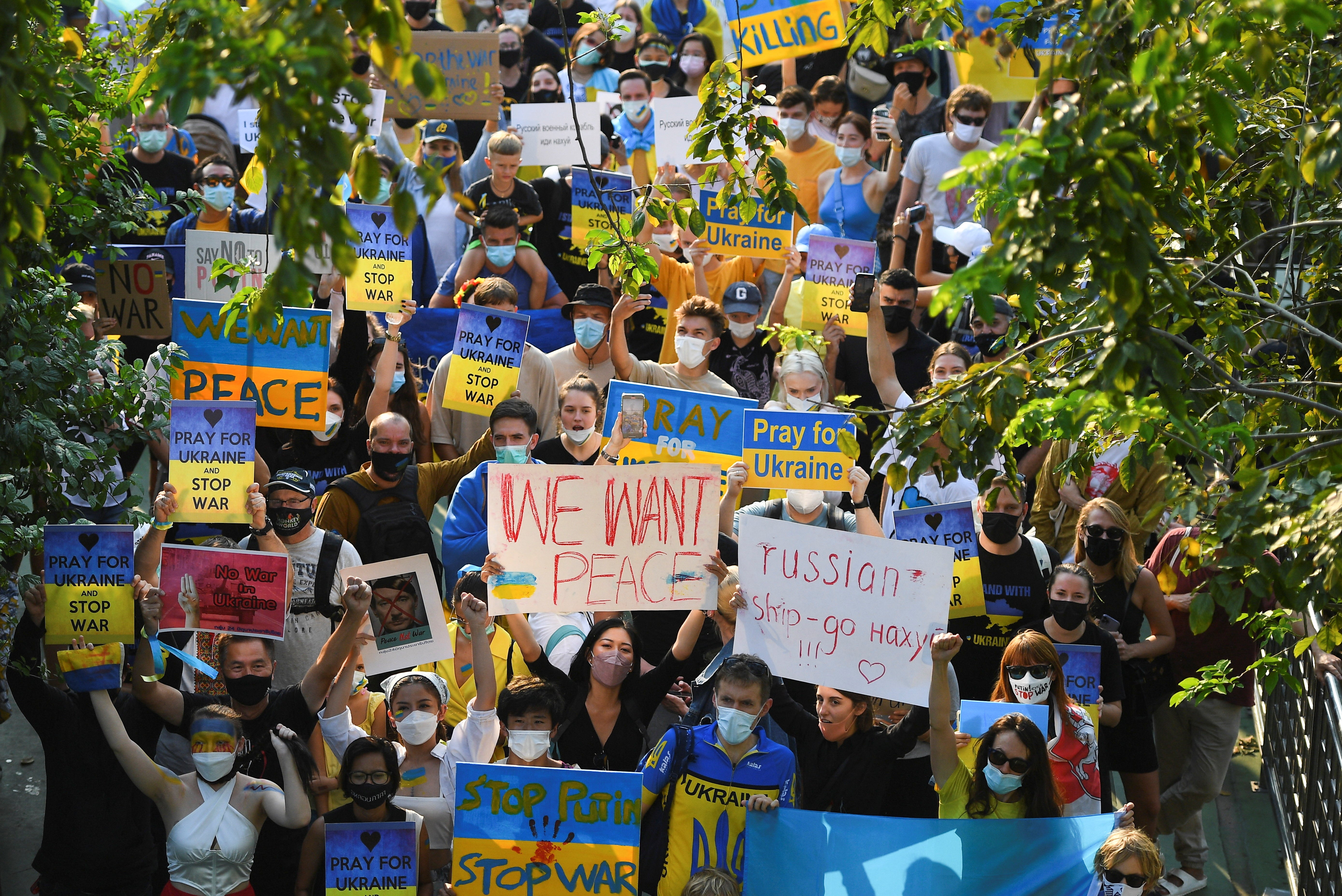 People take part in an anti-war protest, after Russia launched a massive military operation against Ukraine, in Bangkok