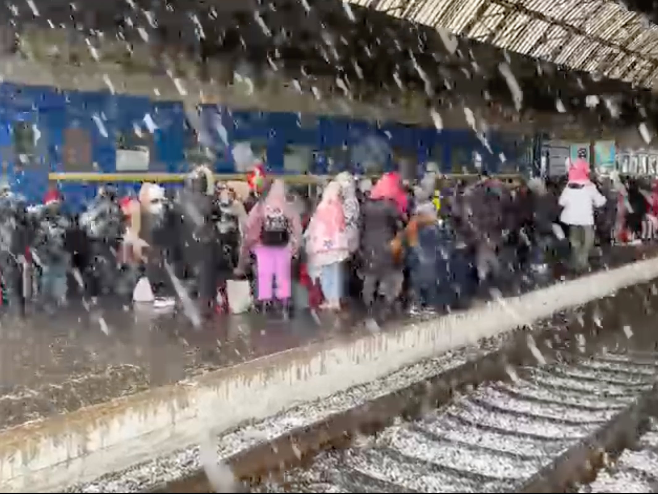 Families waiting at a train station for a way out of Ukraine