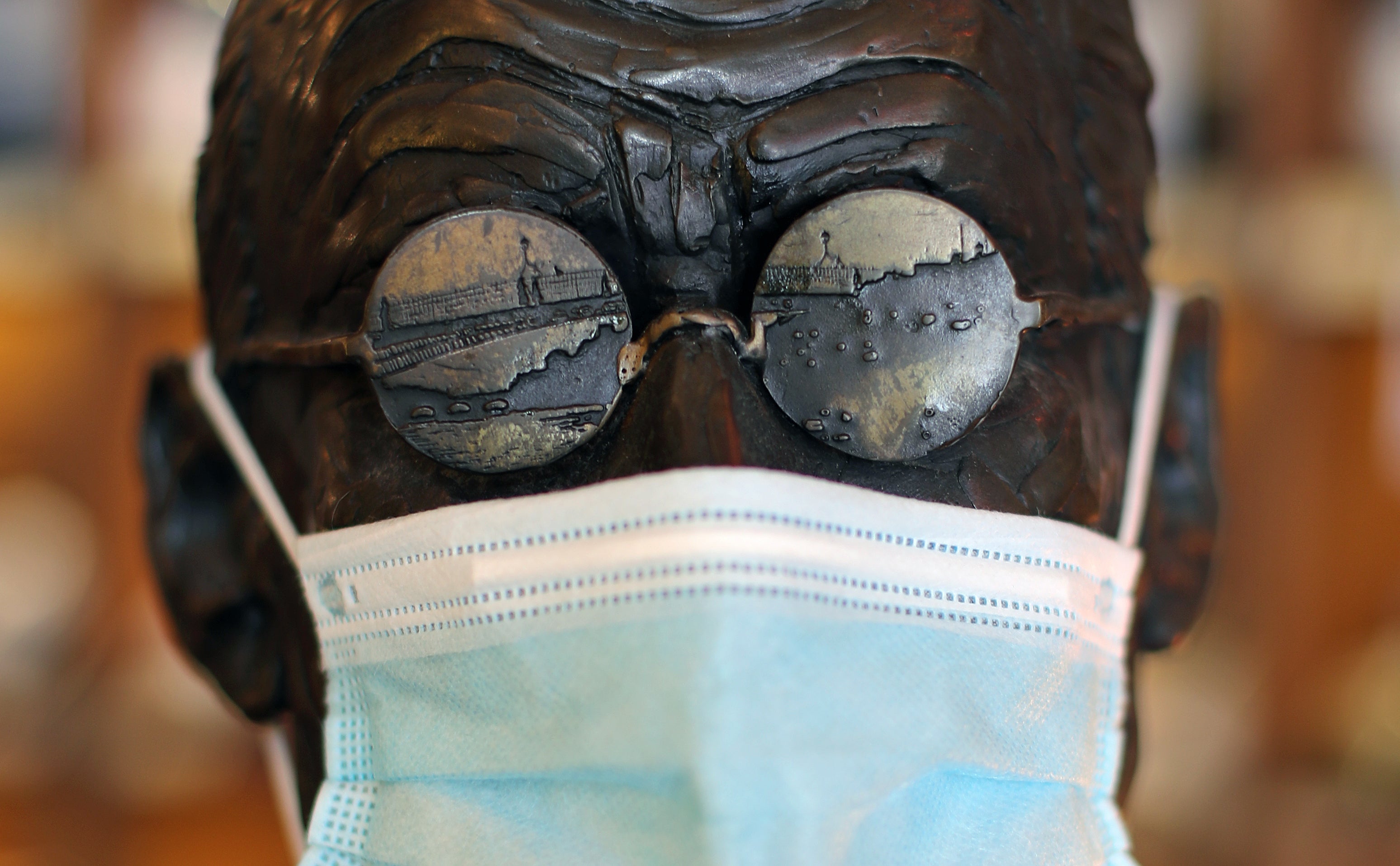 A statue of James Joyce with a Covid-19 face mask in Dublin (Niall Carson/PA)