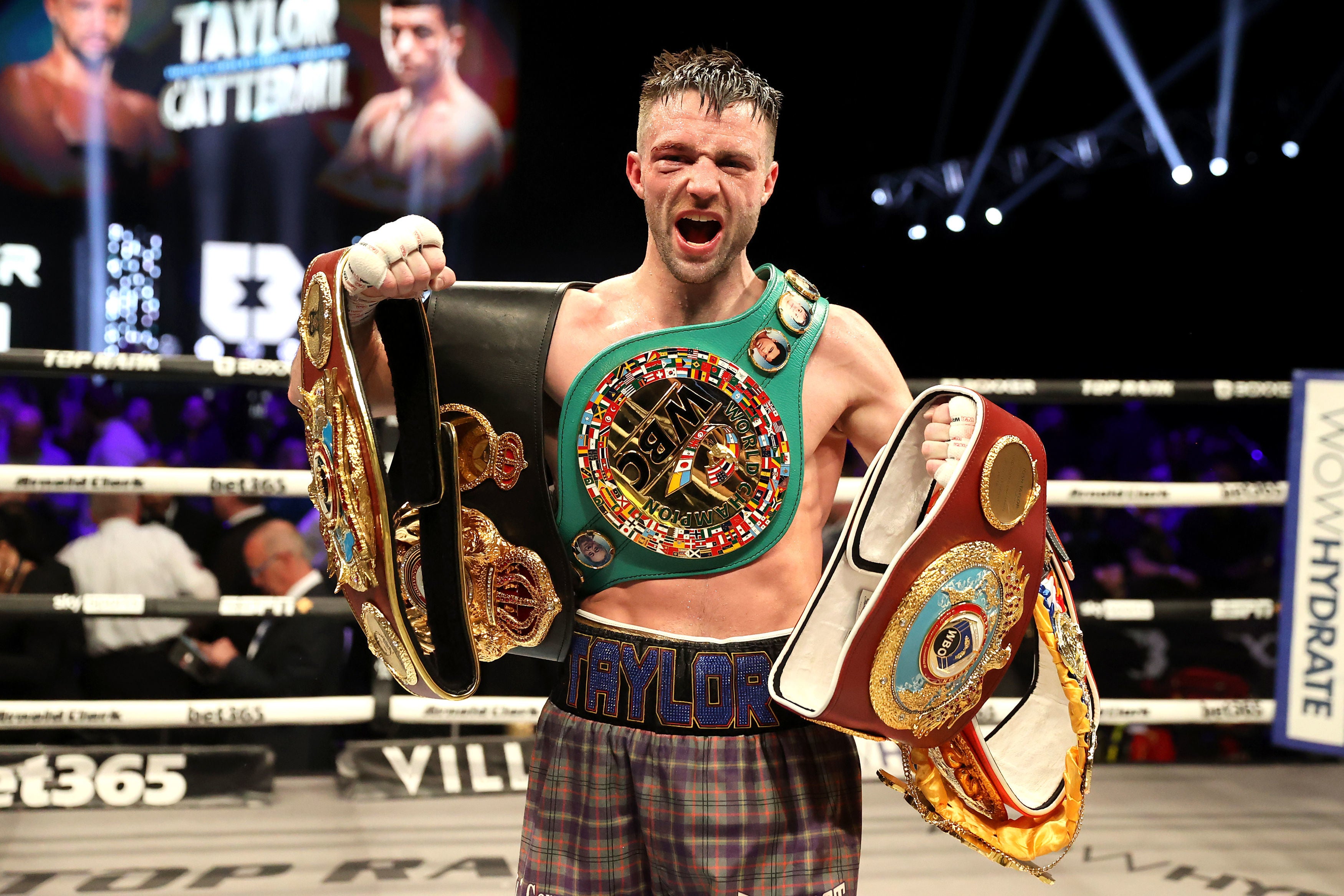 Still champ: Taylor celebrates after his contentious victory over Jack Catterall in Glasgow