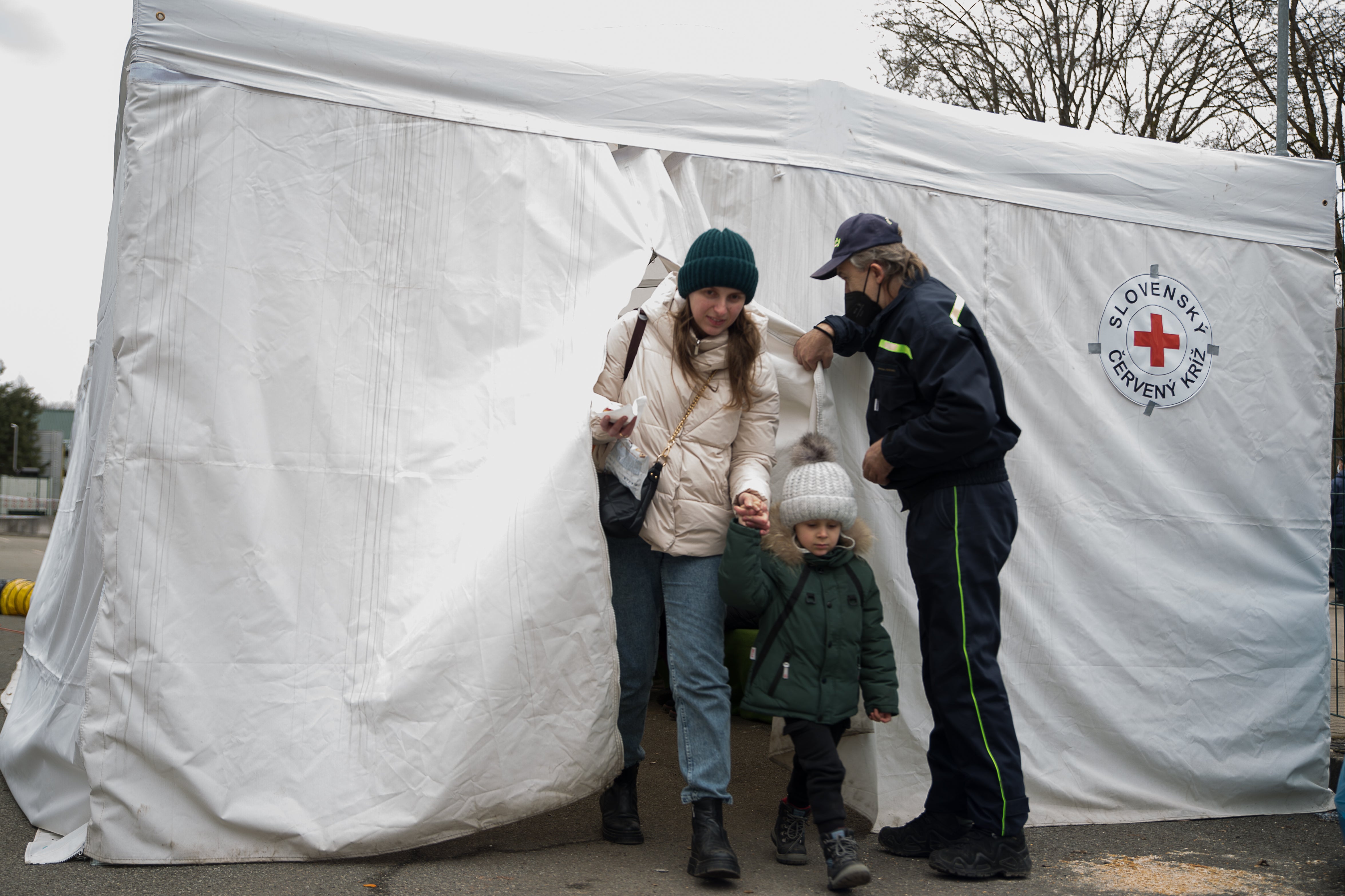 A woman leaves the tent set up by a local Slovak Red Cross for the refugees to take a break after crossing the border to Slovakia in Ubla, 26 February 2022