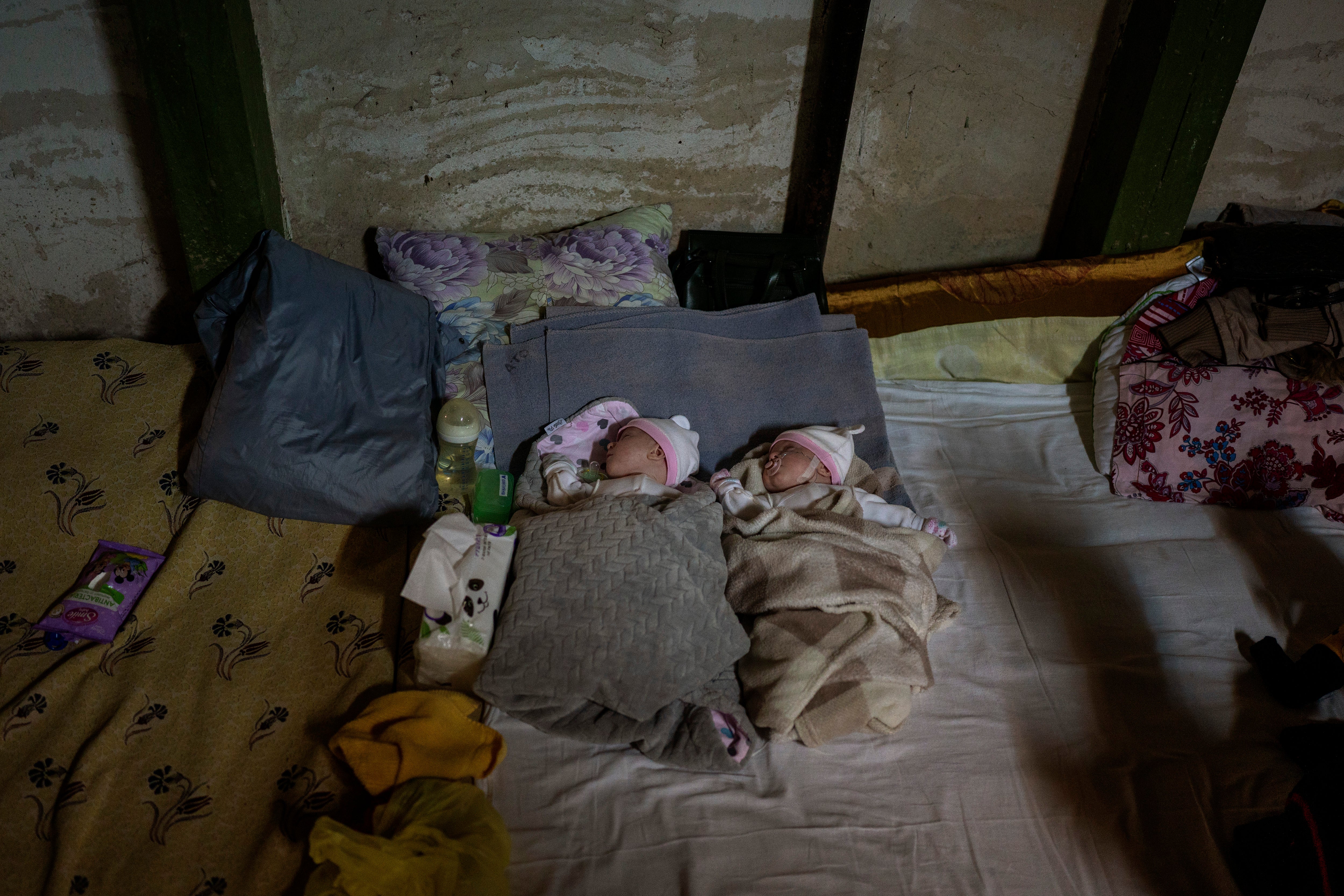 Newborn twin brothers sleep in a basement used as a bomb shelter at the Okhmadet children's hospital in central Kyiv