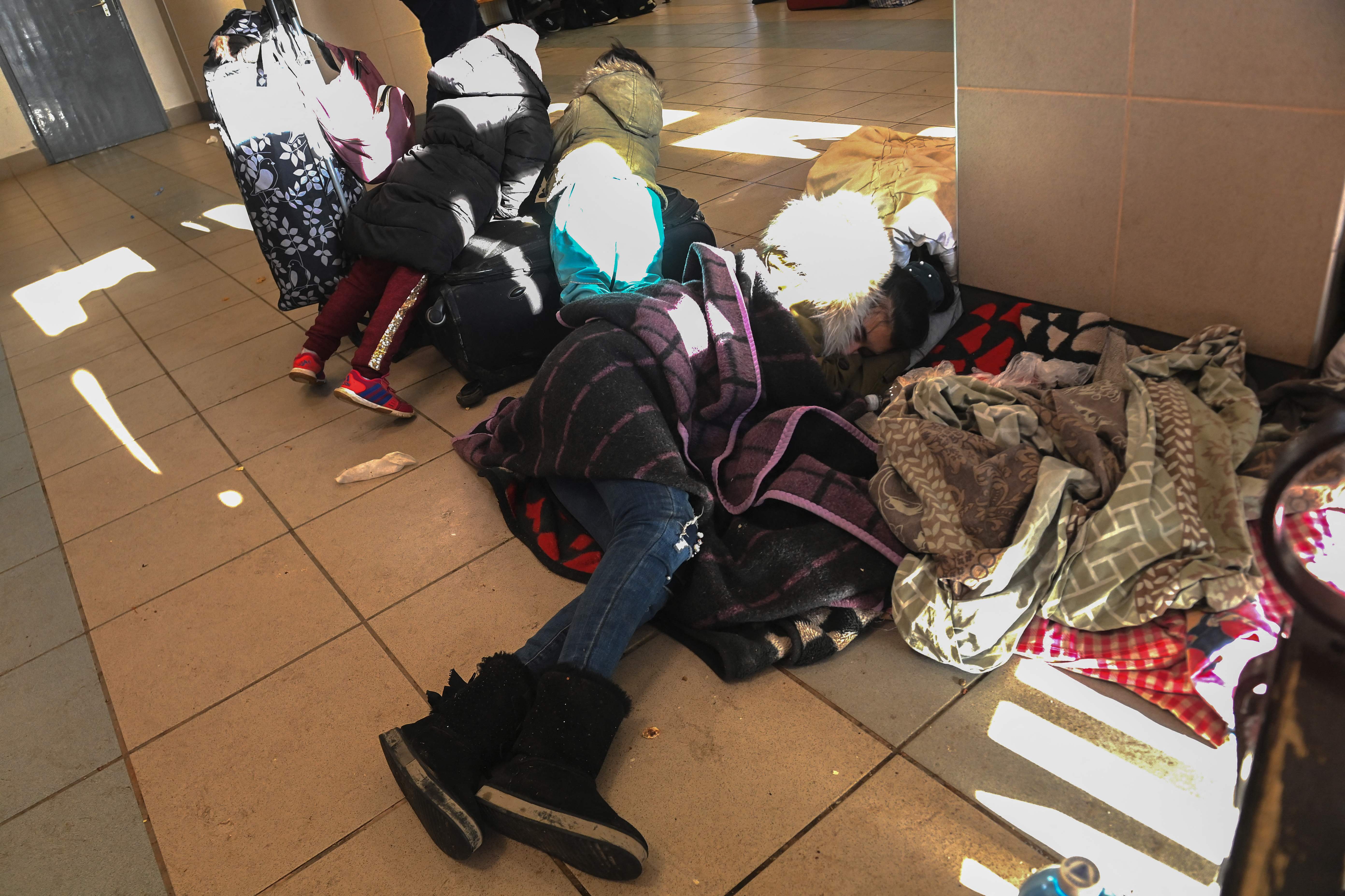 A Ukrainian woman sleeps on the floor of the railway station in Zahonyi close to the Hungarian Ukrainian border