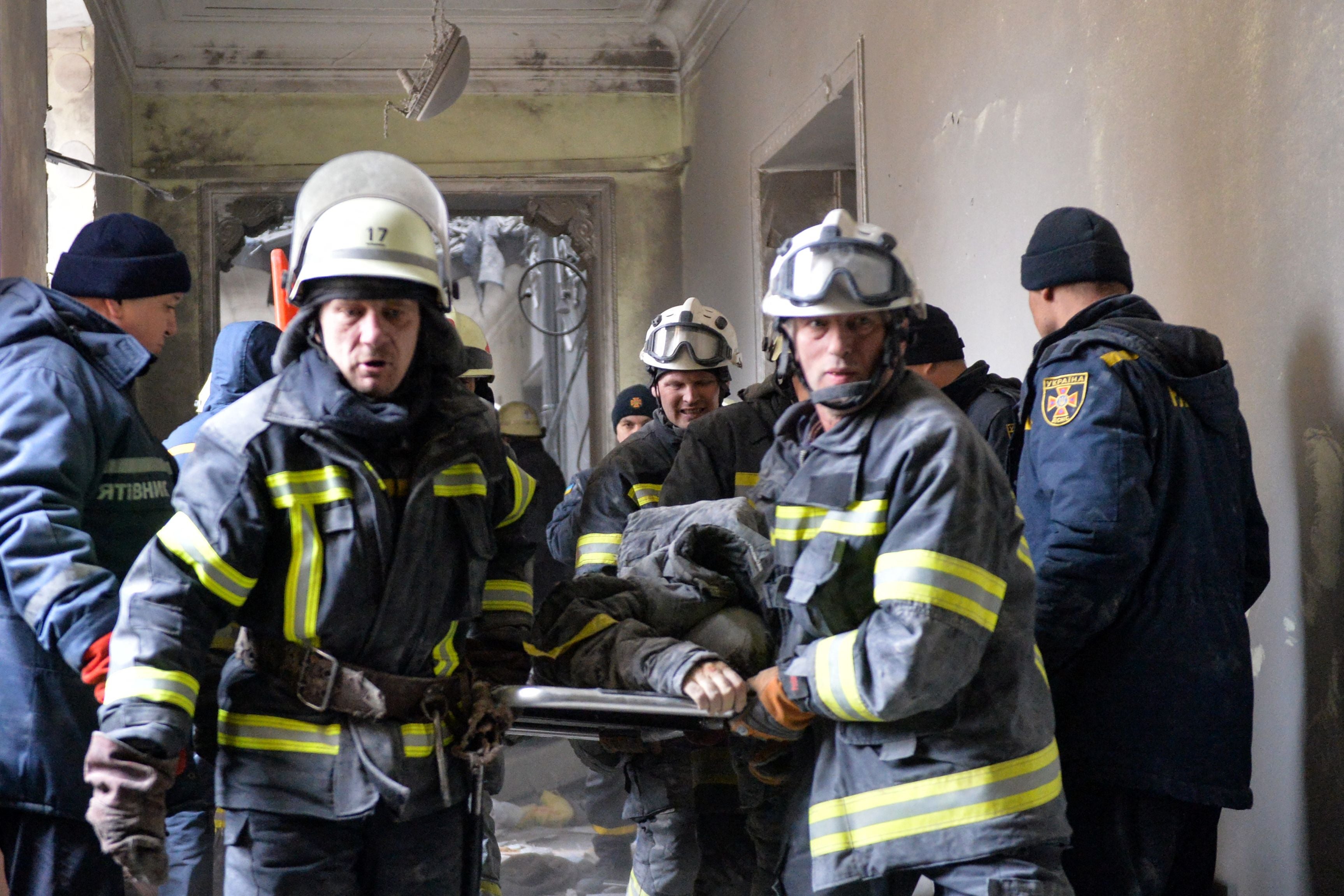 Emergencies personnel carry a body out of the damaged local city hall of Kharkiv on 1 March 2022