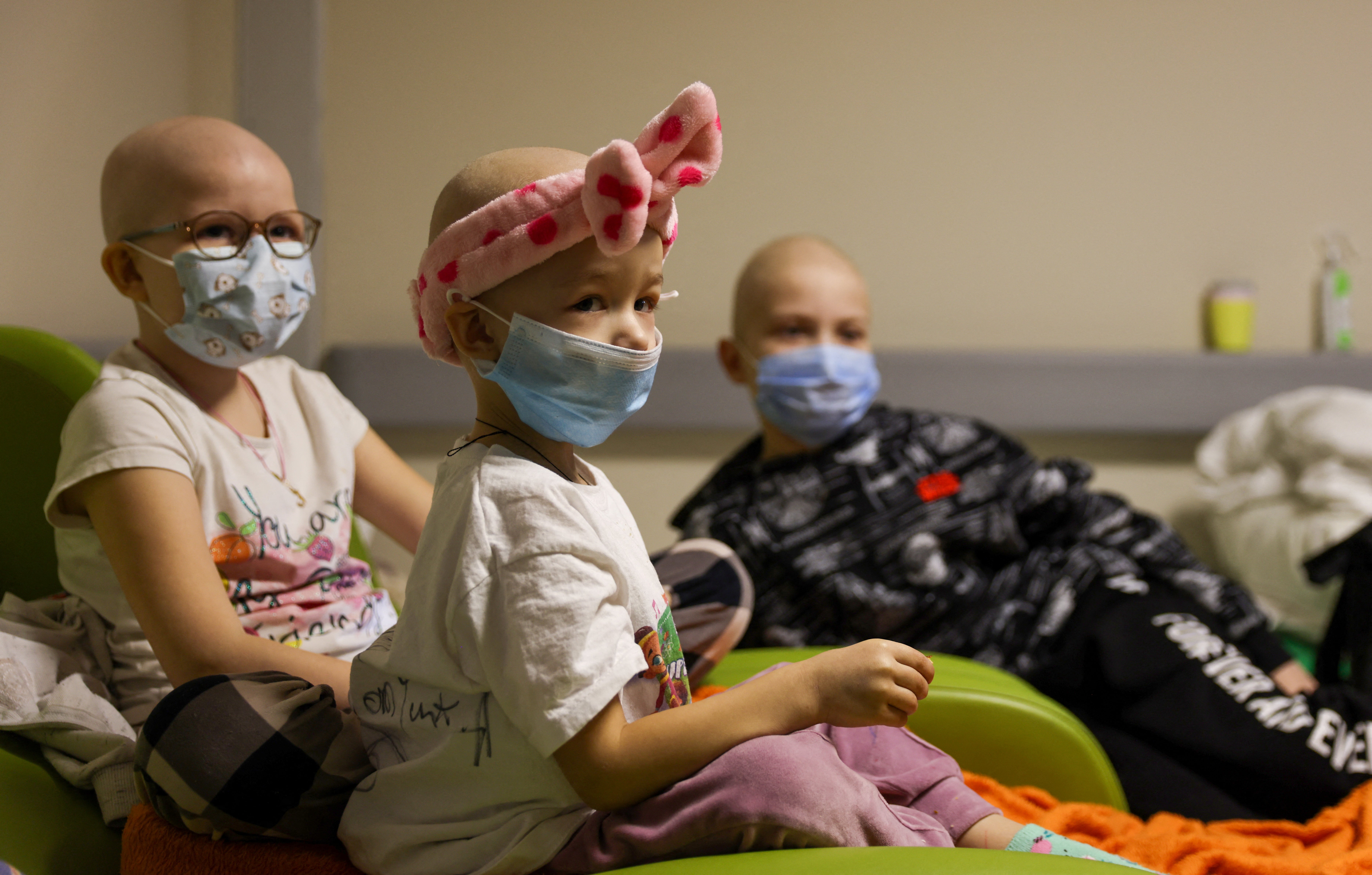 Children patients whose treatments are underway sit on chairs moved to the hallways of basement floors of Okhmadet Children’s Hospital