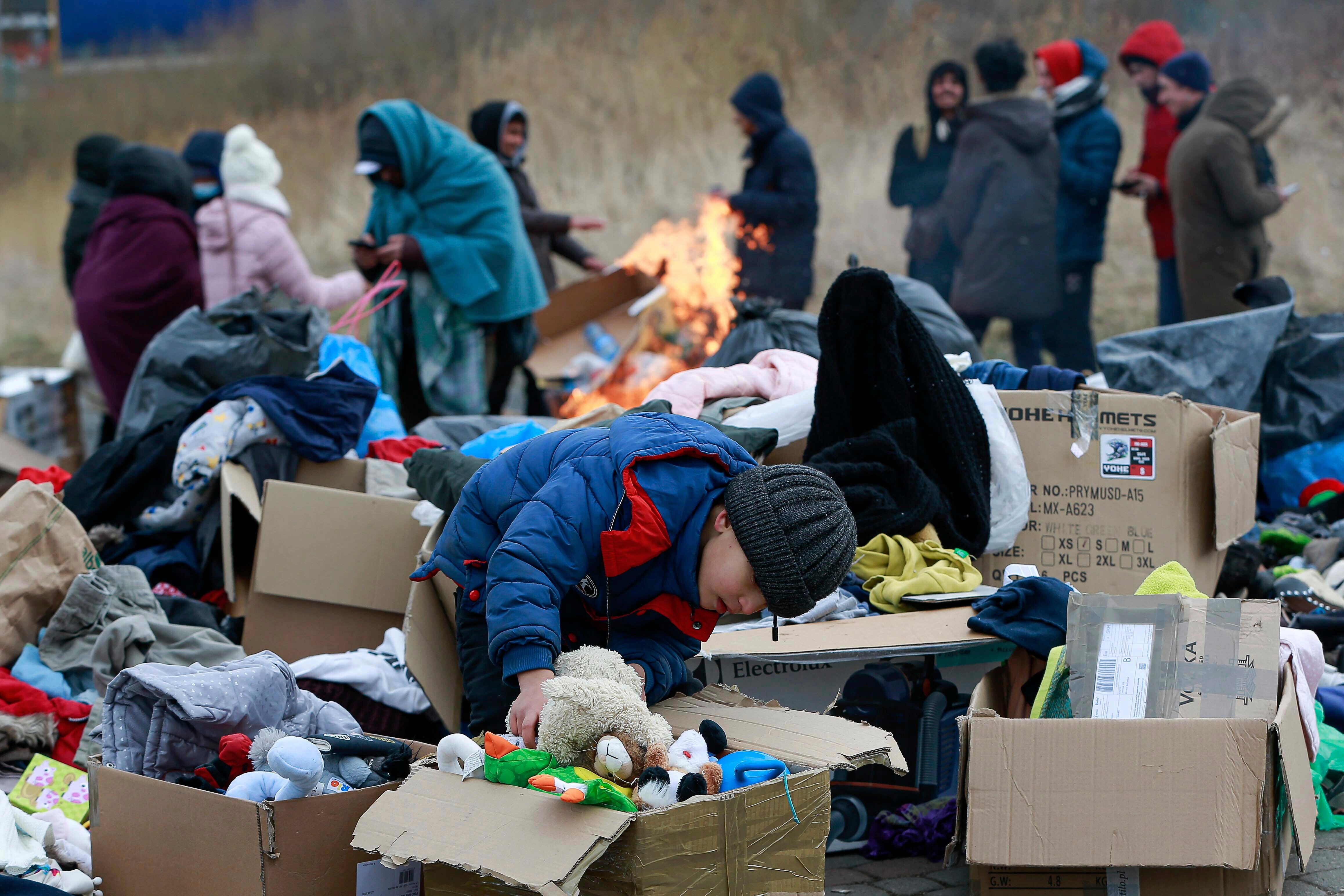 A child collects toys near a donation point at the Medyka border crossing in Poland