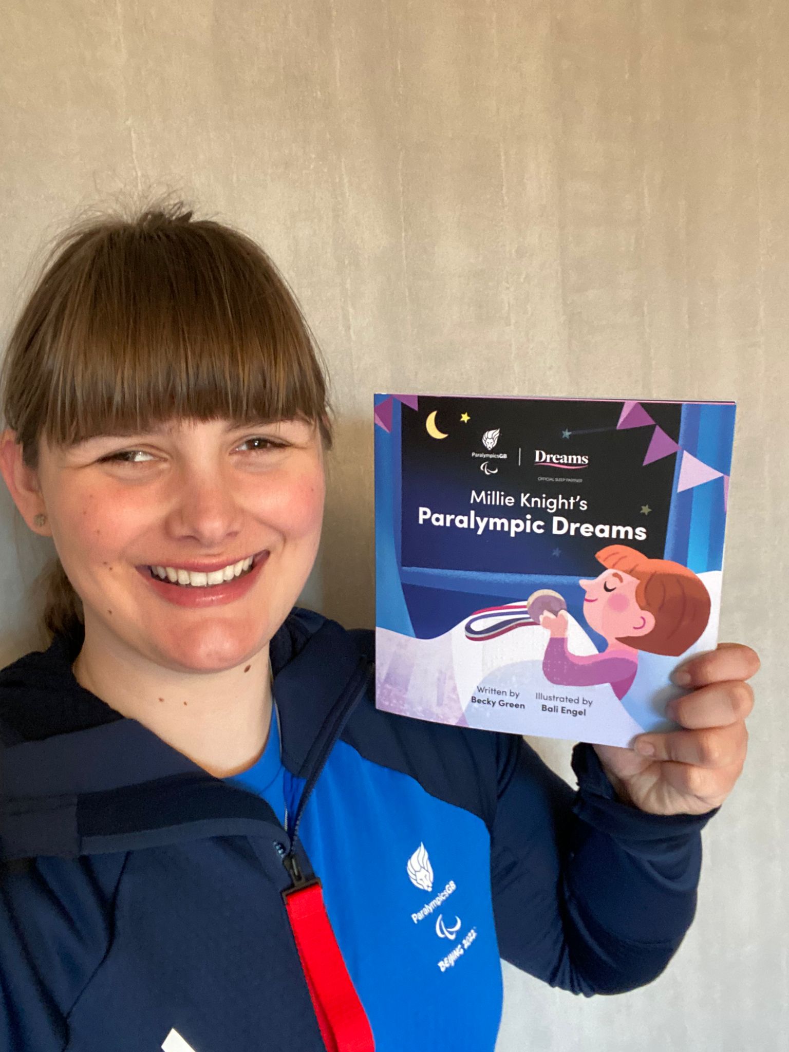 Knight poses with the children’s book about her story