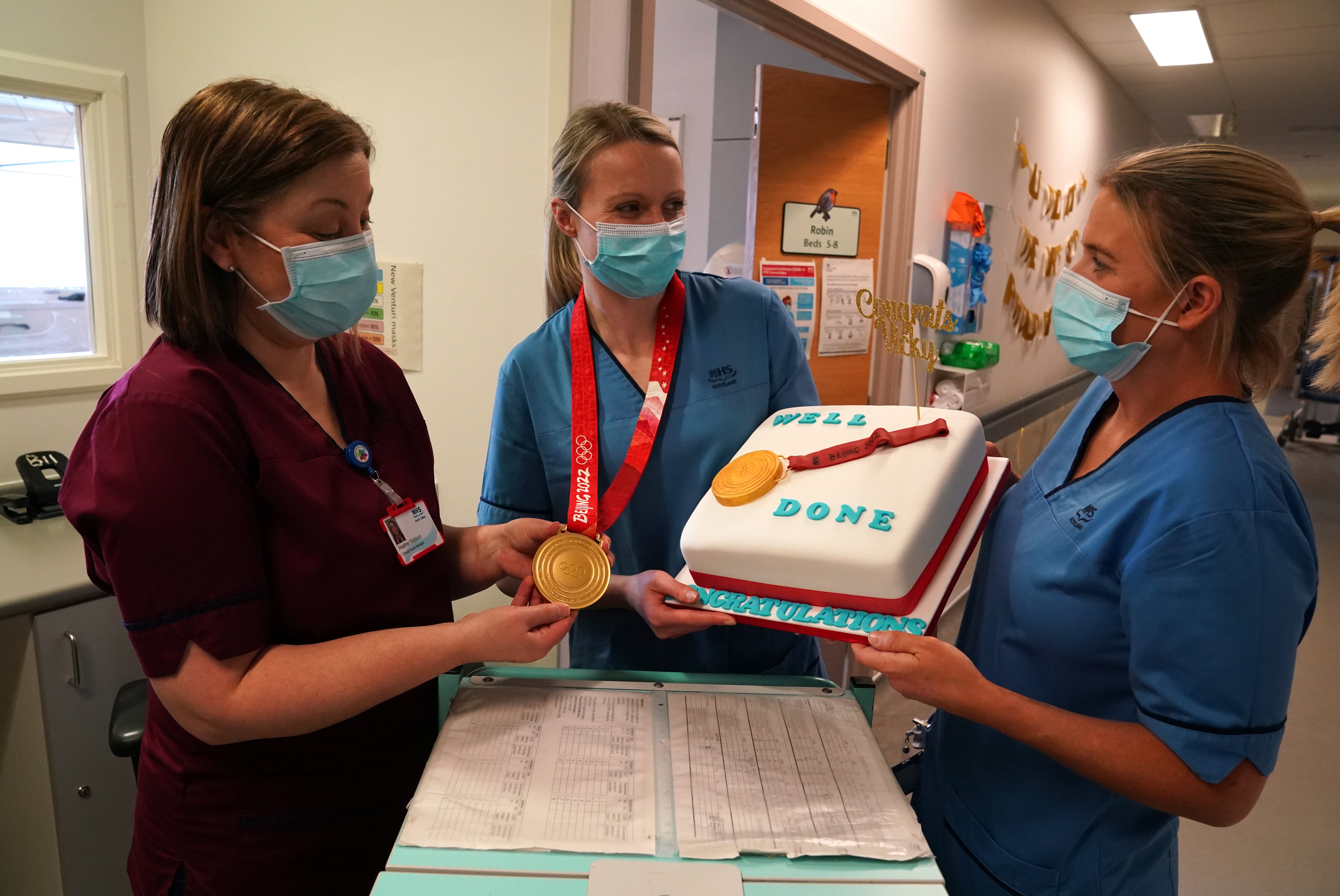 Vicky Wright shows off her medal to colleagues Heather Riddoch (left) and Lisa McCann (Andrew Milligan/PA)