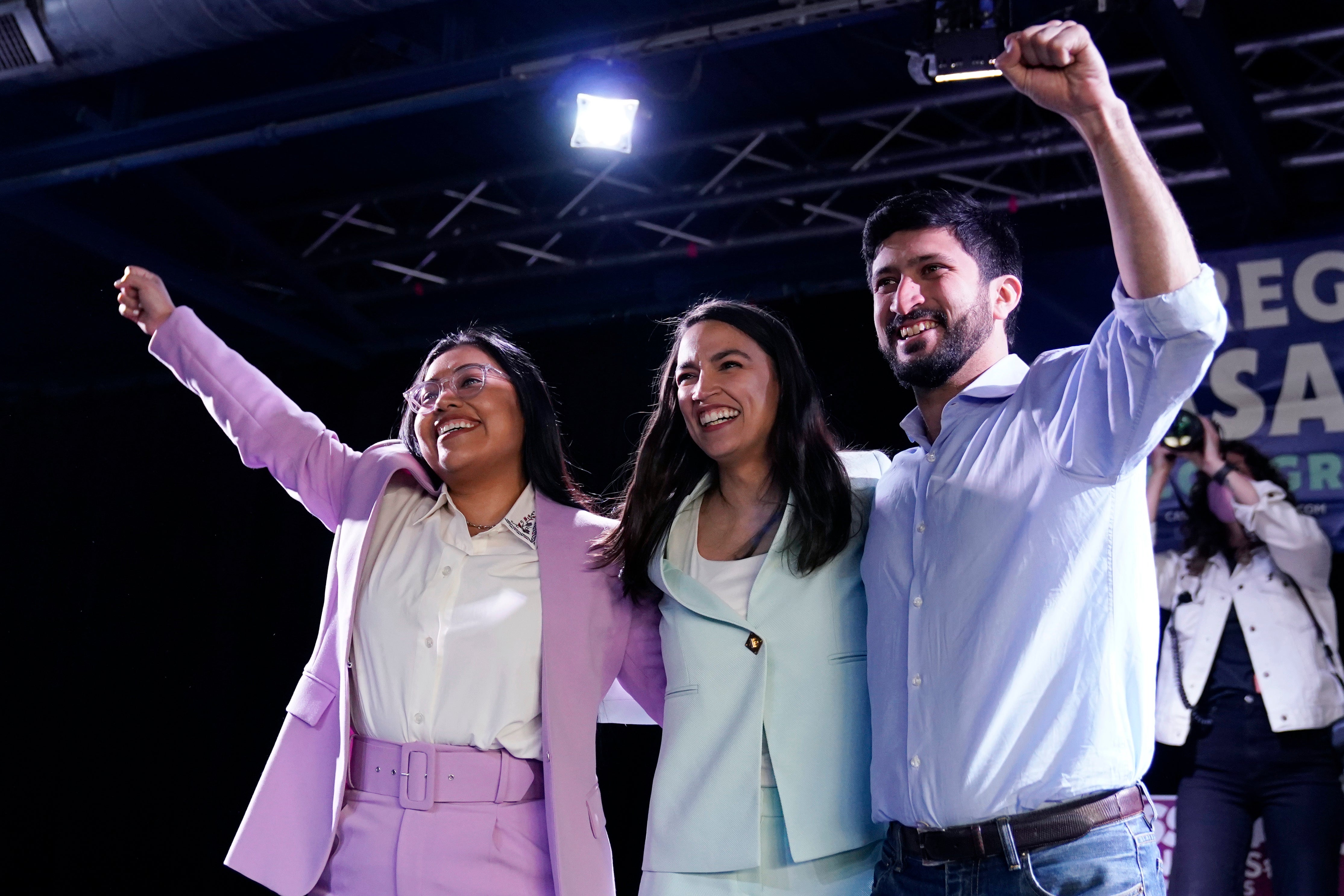 U.S. Rep. Alexandria Ocasio-Cortez, center, joins a rally for Democratic Congressional candidates Jessica Cisneros, left, and Greg Casar on February 12