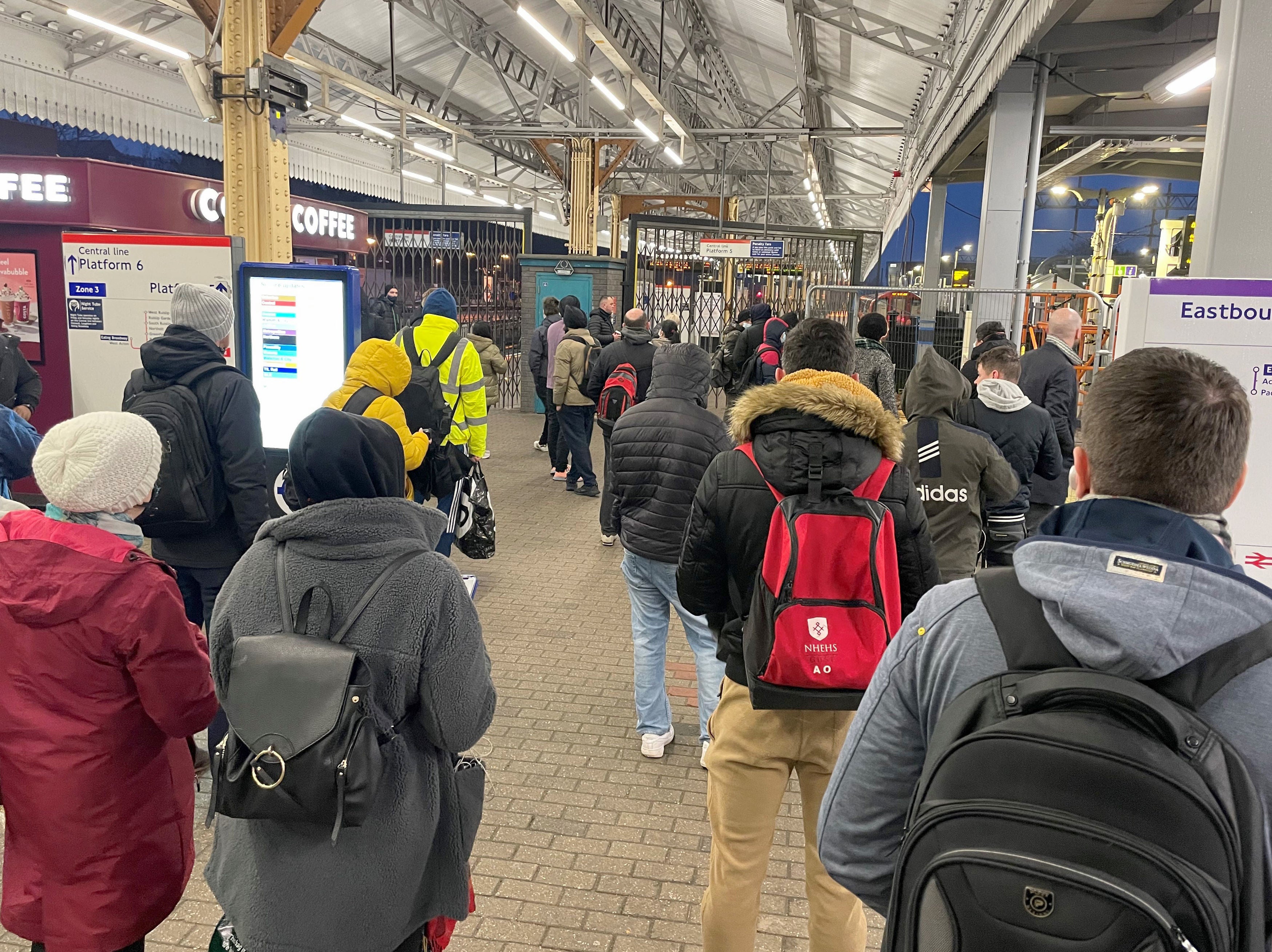 Commuters wait for underground services to resume at Ealing Broadway tube station in London on 2 March 2022