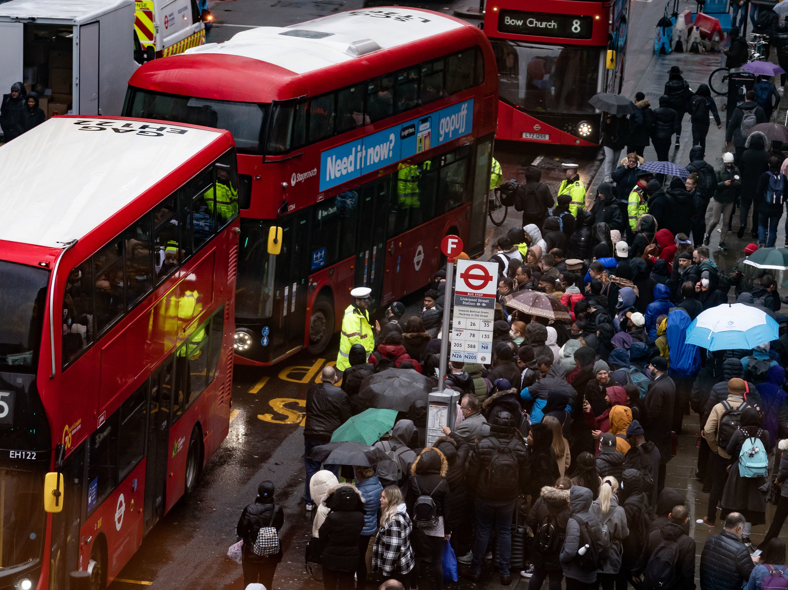 People wait to get on buses at Liverpool Street station in central London during Tube strike action on 1 March 2022