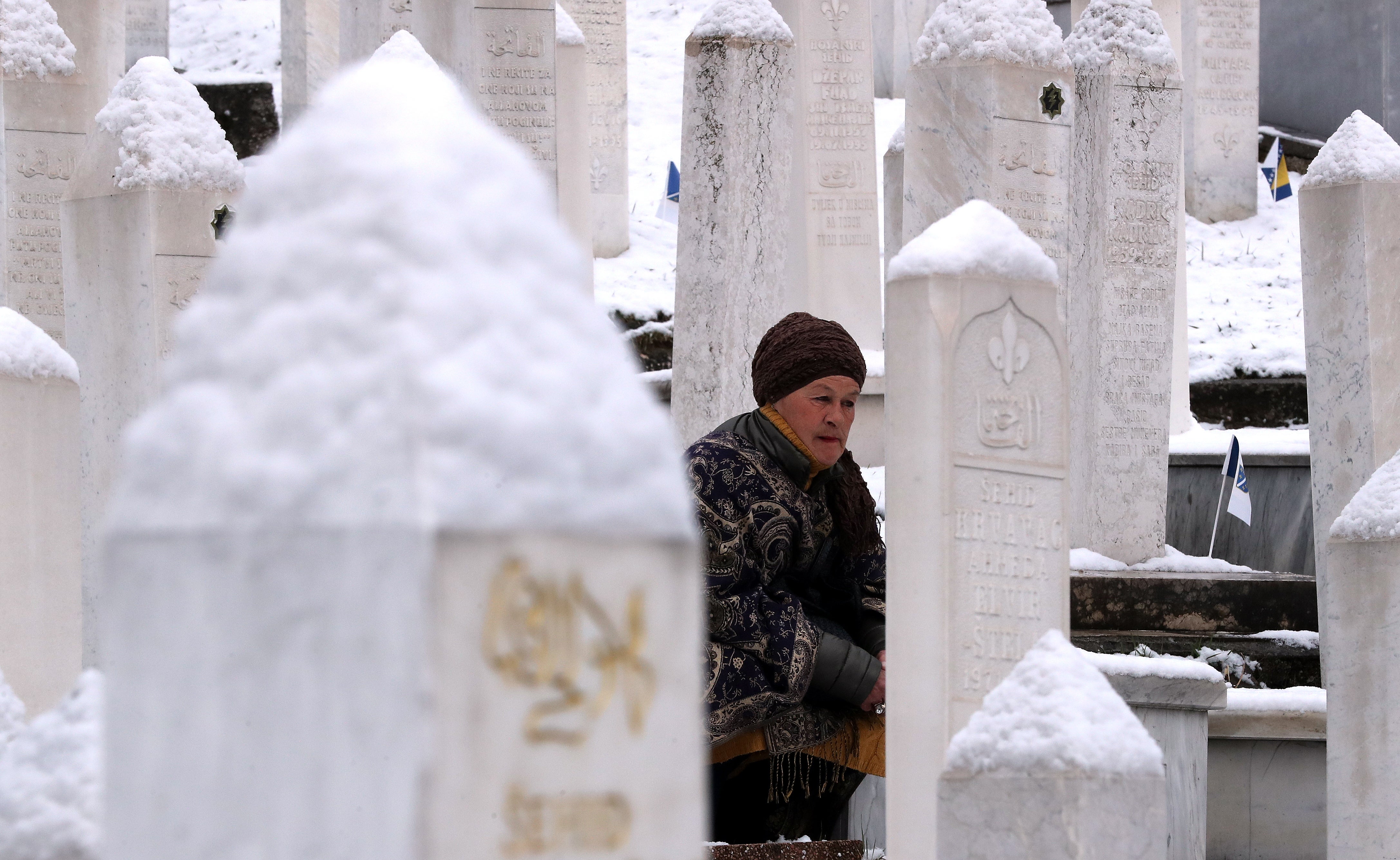 A women prays on the 30th anniversary of Bosnian Independence at a memorial to the fallen soldiers in the war in Sarajevo, earlier this week