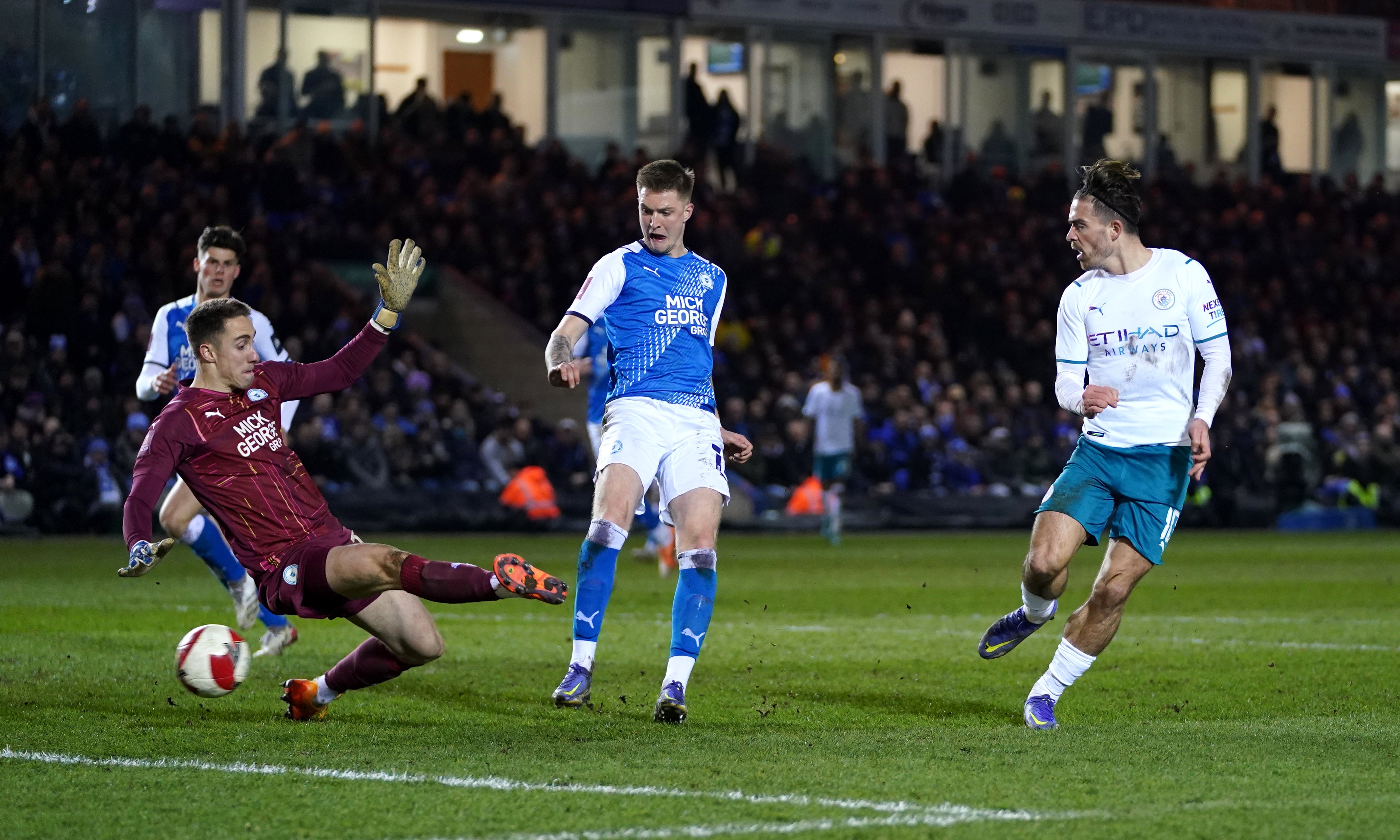 Manchester City’s Jack Grealish (right) scores against Peterborough (Joe Giddens/PA).