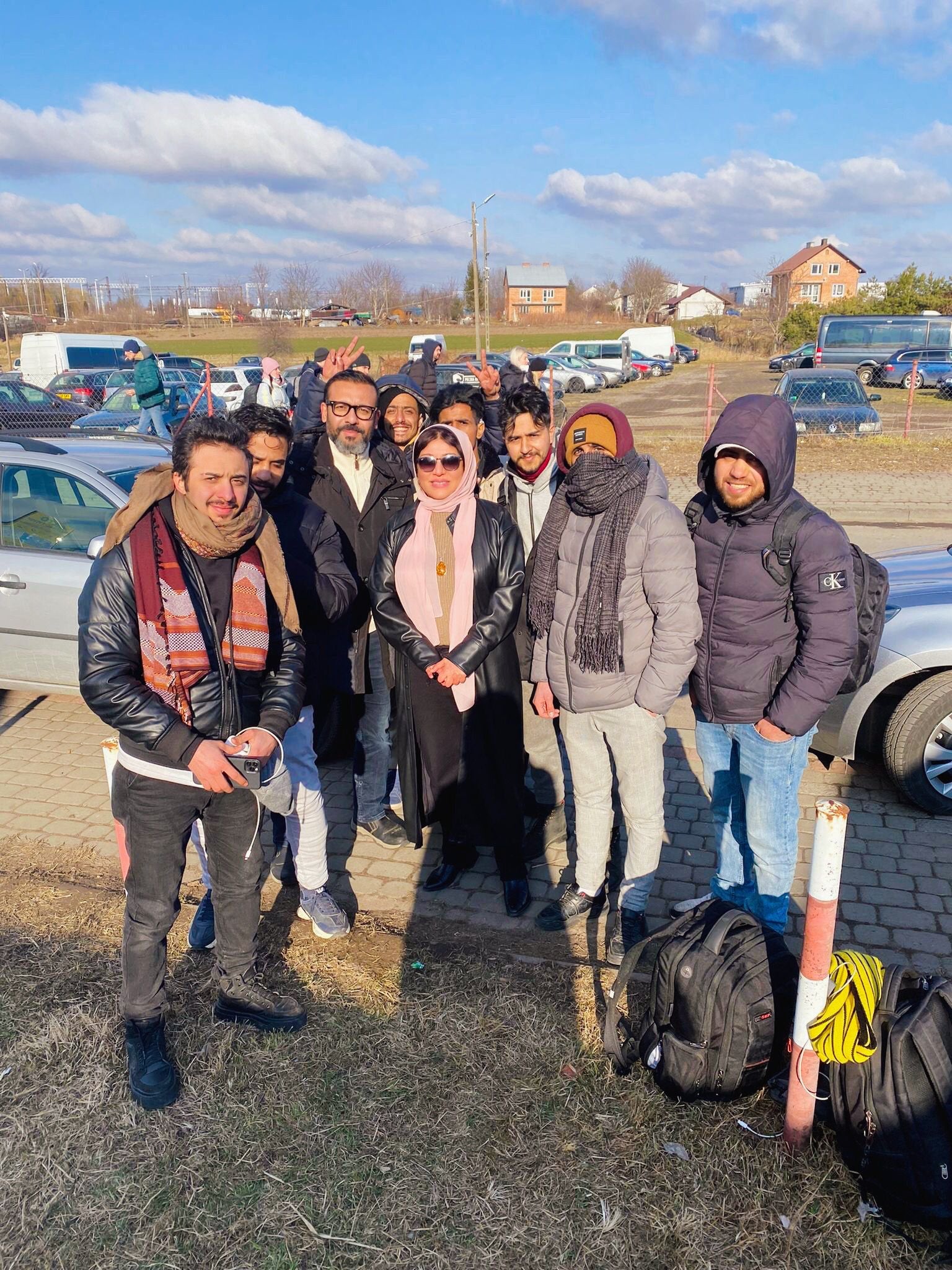 A group of Yemeni students who fled Ukraine into Poland seen at the border with Yemeni ambassador to Poland and Ukraine, Dr Mervat Mojali