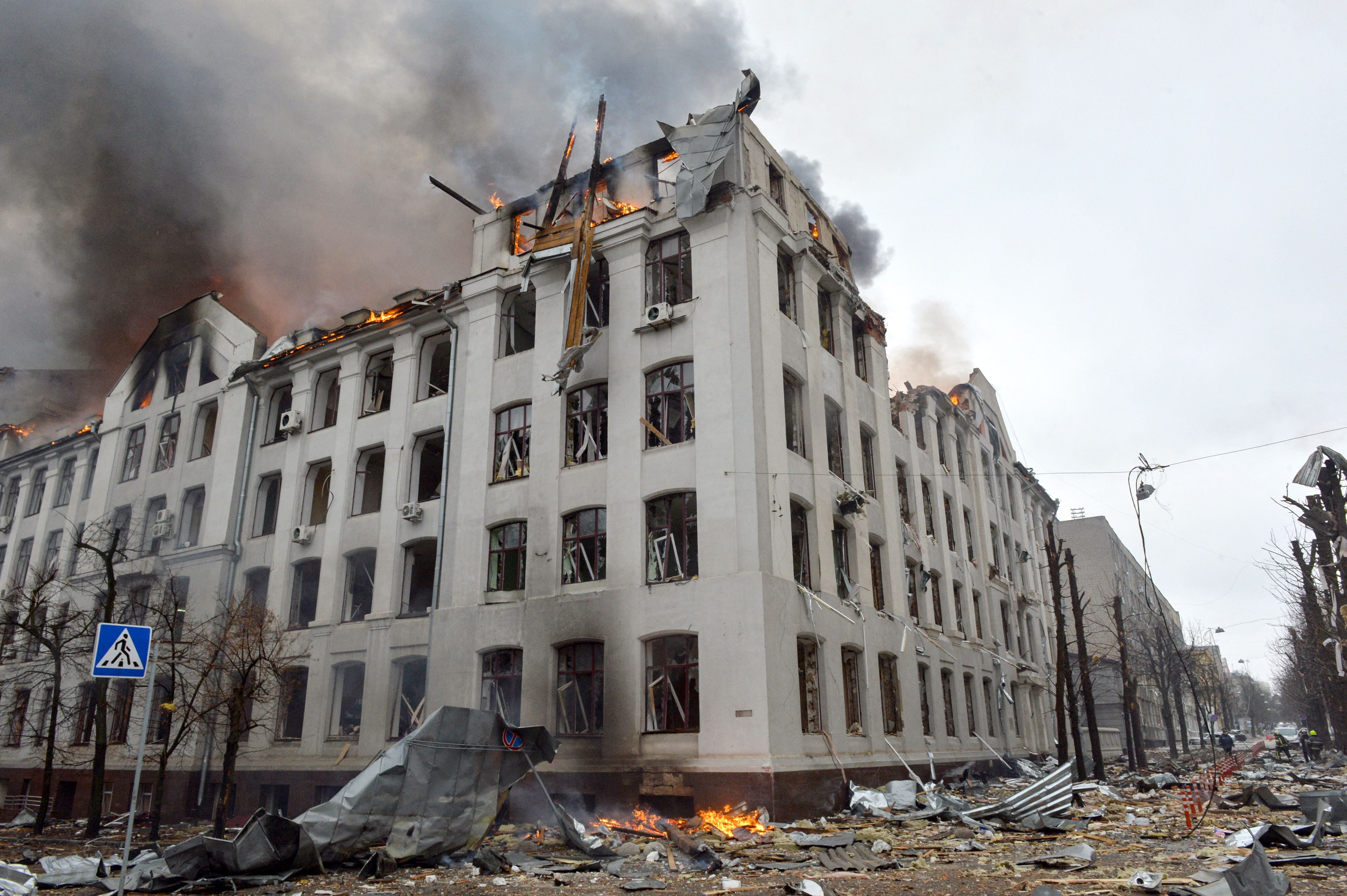 Firefighters work to contain a fire at the economics department building of Karazin Kharkiv National University, hit during recent shelling by Russia