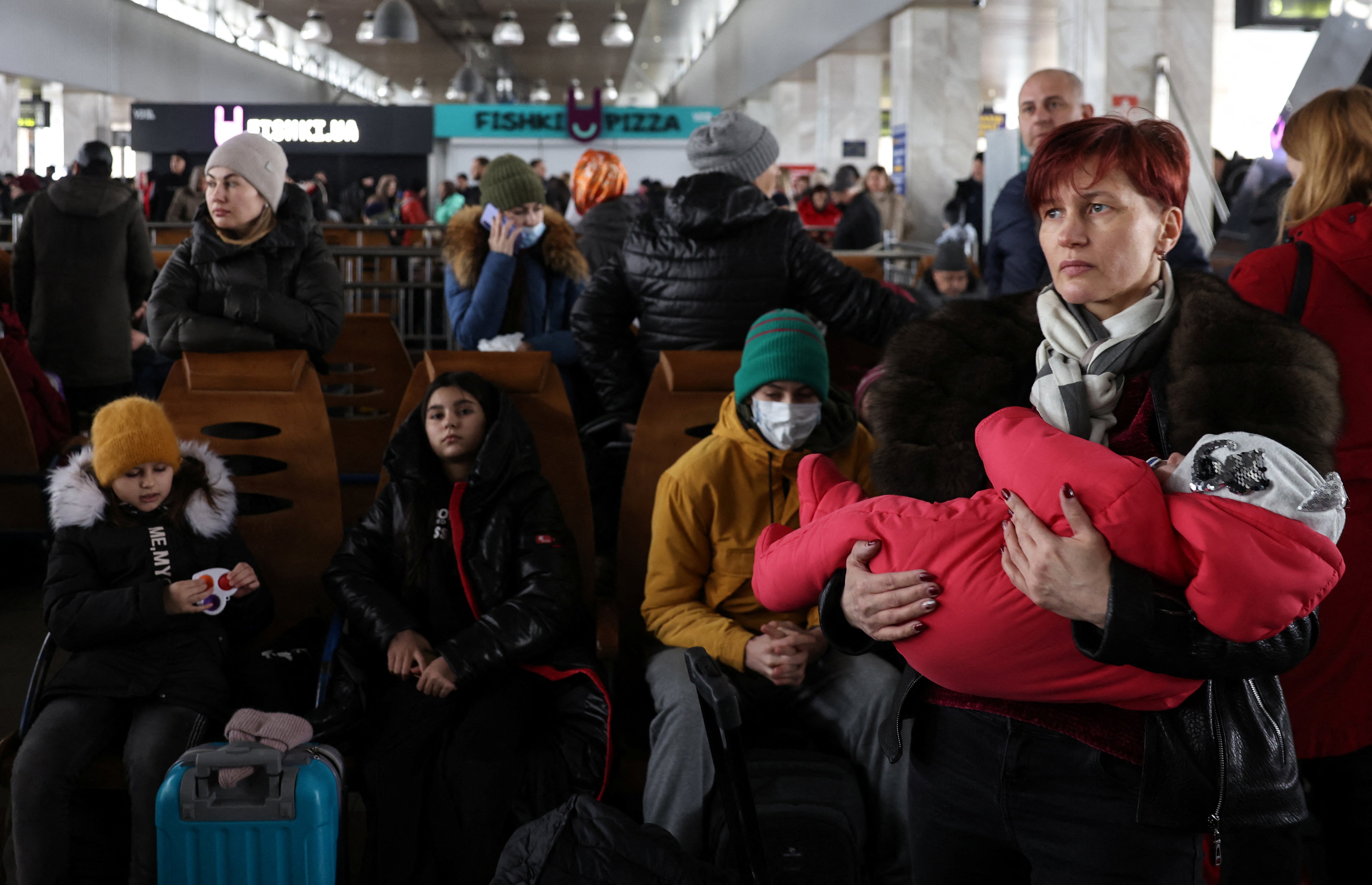 People wait to board an evacuation train from Kyiv to Lviv at Kyiv central train station following Russia's invasion of Ukraine