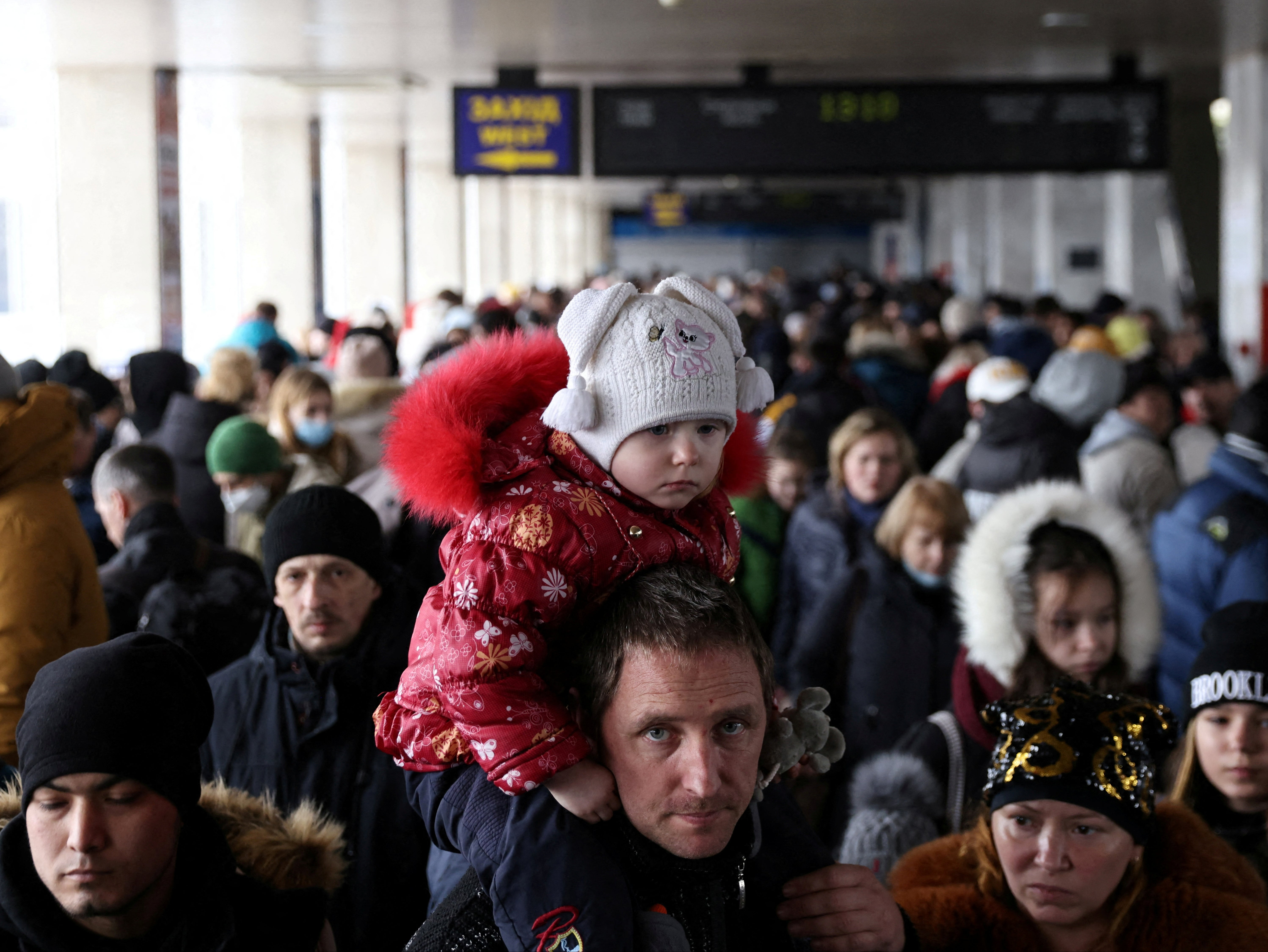 People wait to board an evacuation train from Kyiv to Lviv at Kyiv central train station following Russia's invasion of Ukraine